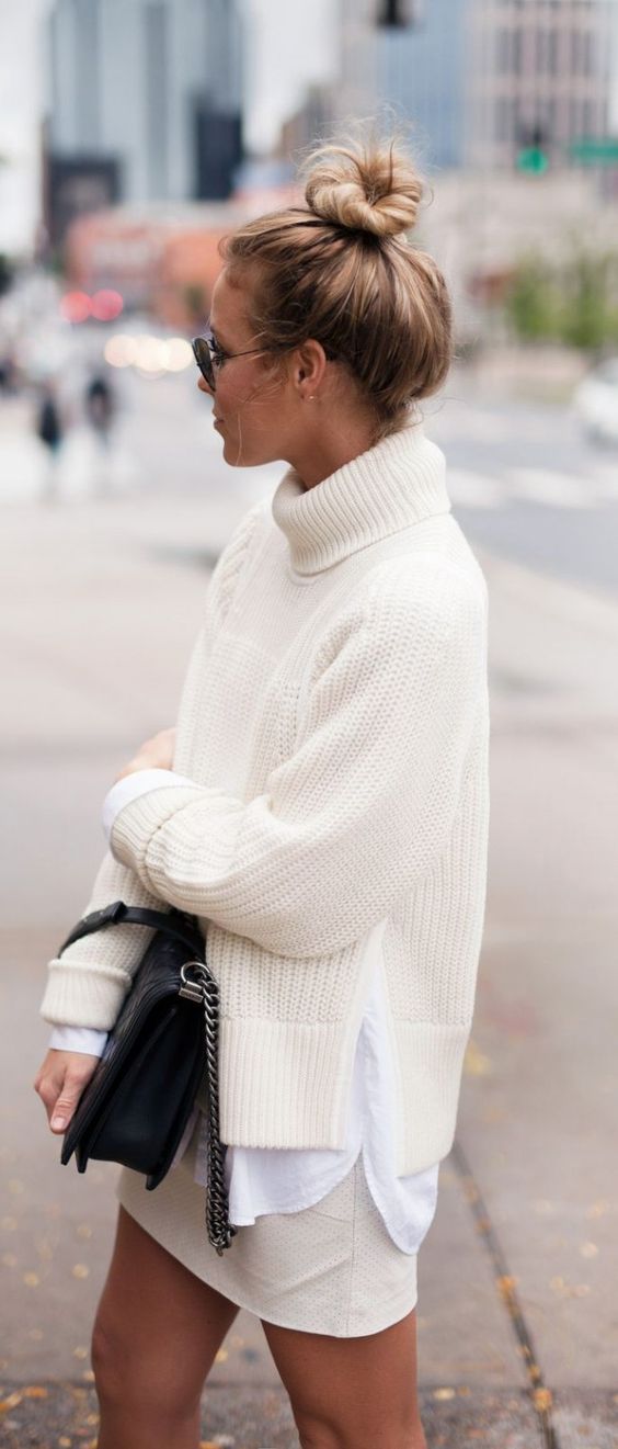 blonde haired model wearing ivory knit sweater and ivory skirt with black sunglasses