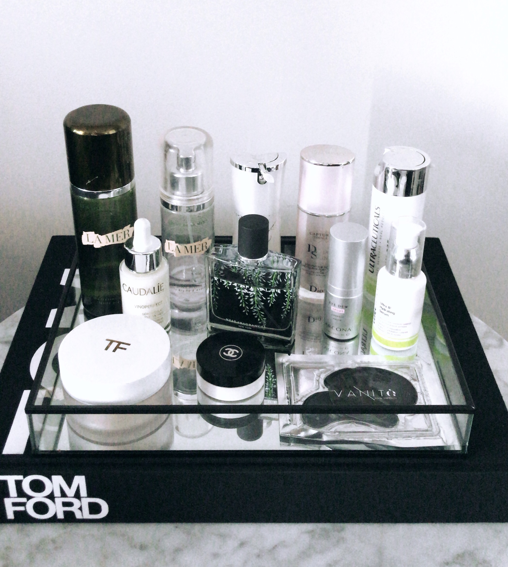 A range of Tom Ford beuty products standing on a black tray