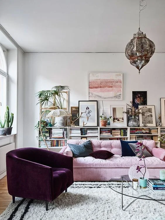 White living room with pink sofa and maroon chair