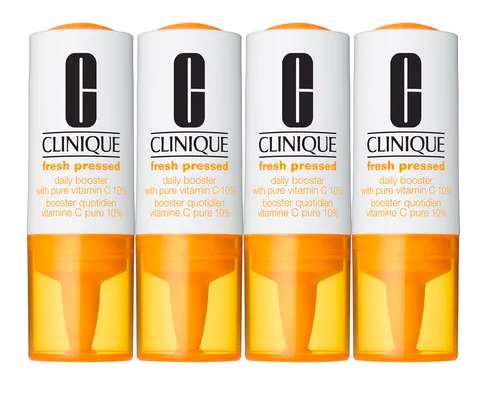 Four white Clinique booster vials with orange lids lined up in a row