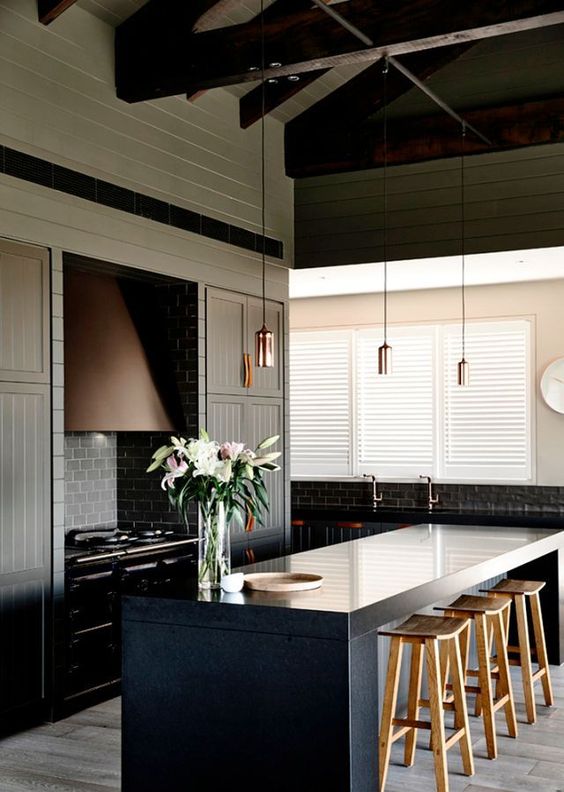 Modern kitchen with black bench and flowers