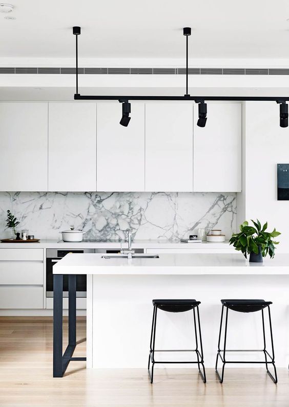 modern white kitchen with marble feature wall