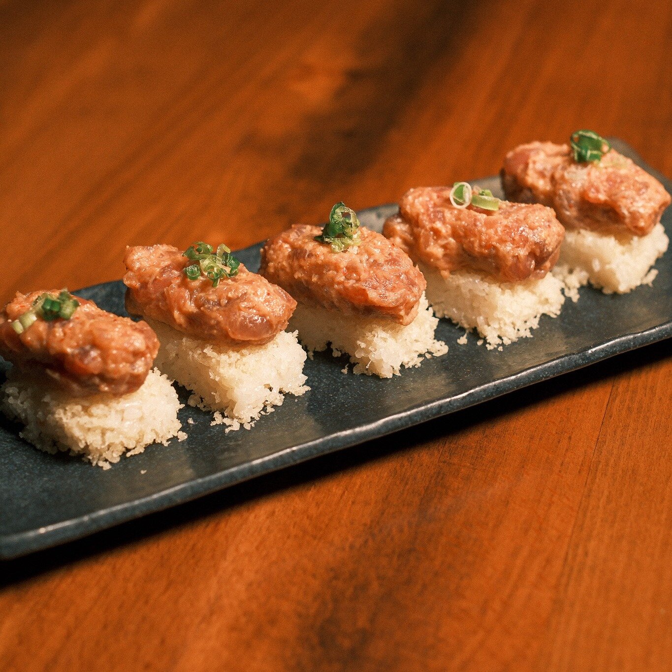 Introducing Nare Sushi's Crispy Battera (aka Crispy Rice): our version combines box-pressed sushi rice with tempura flakes. Choose from Spicy Tuna with scallion, Salmon with fried garlic and tomato sauce, or Yellowtail with Jalapeno and ponzu sauce. 
