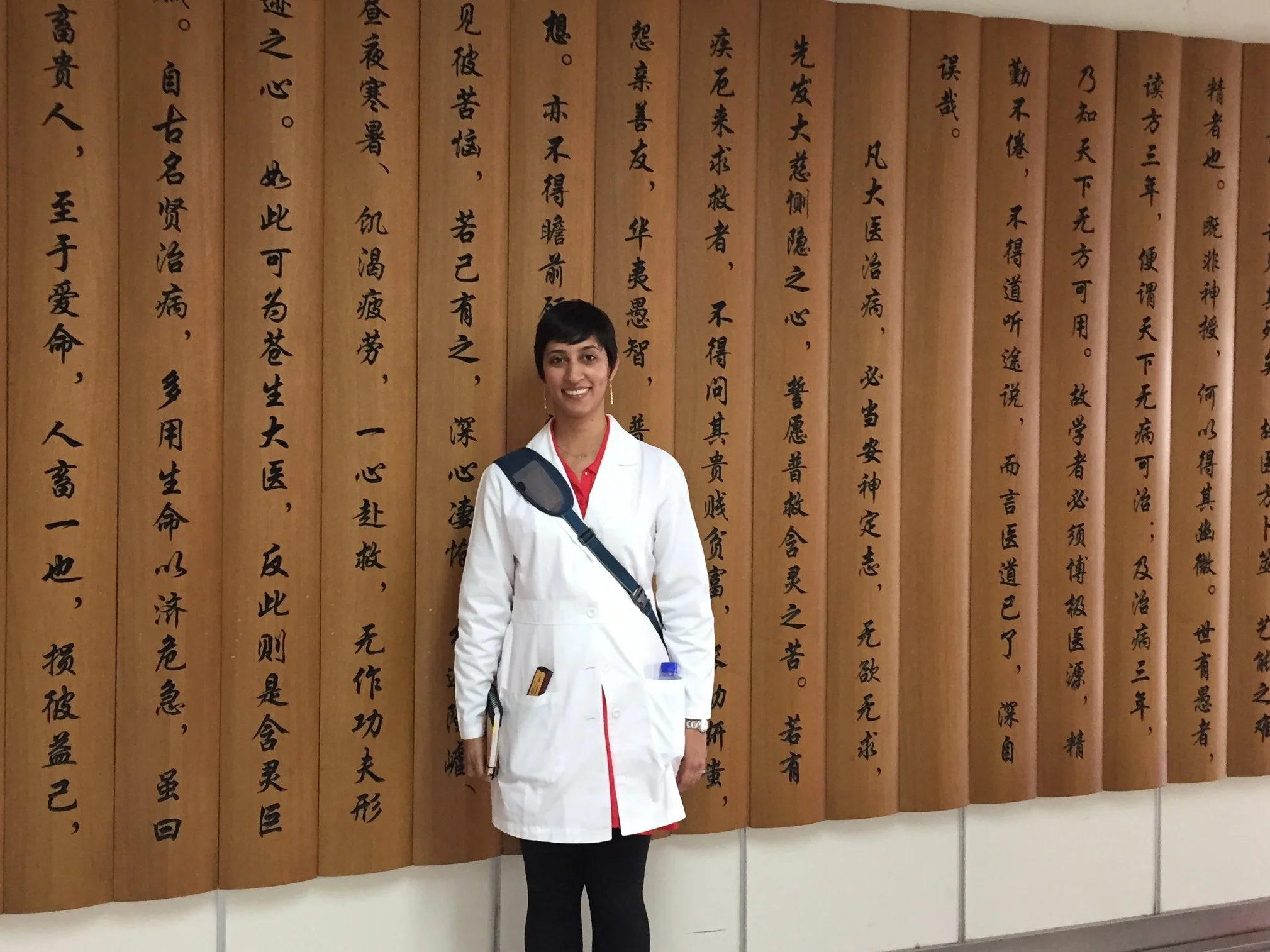 Photo of Shawna at the new Tianjin Hospital in China in front of Sun Si Miao's Oath