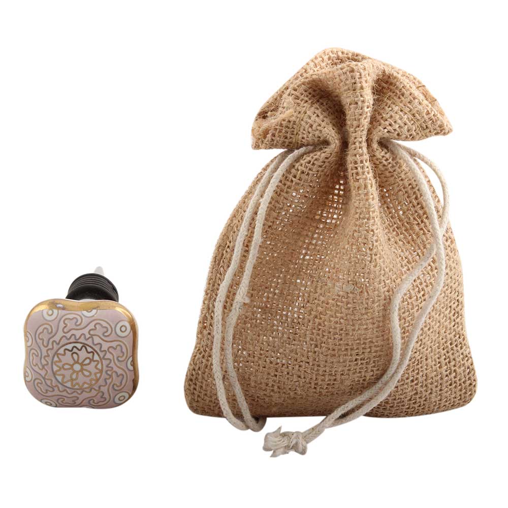 Bottlestopper pink sea swirls next to satchel.JPG