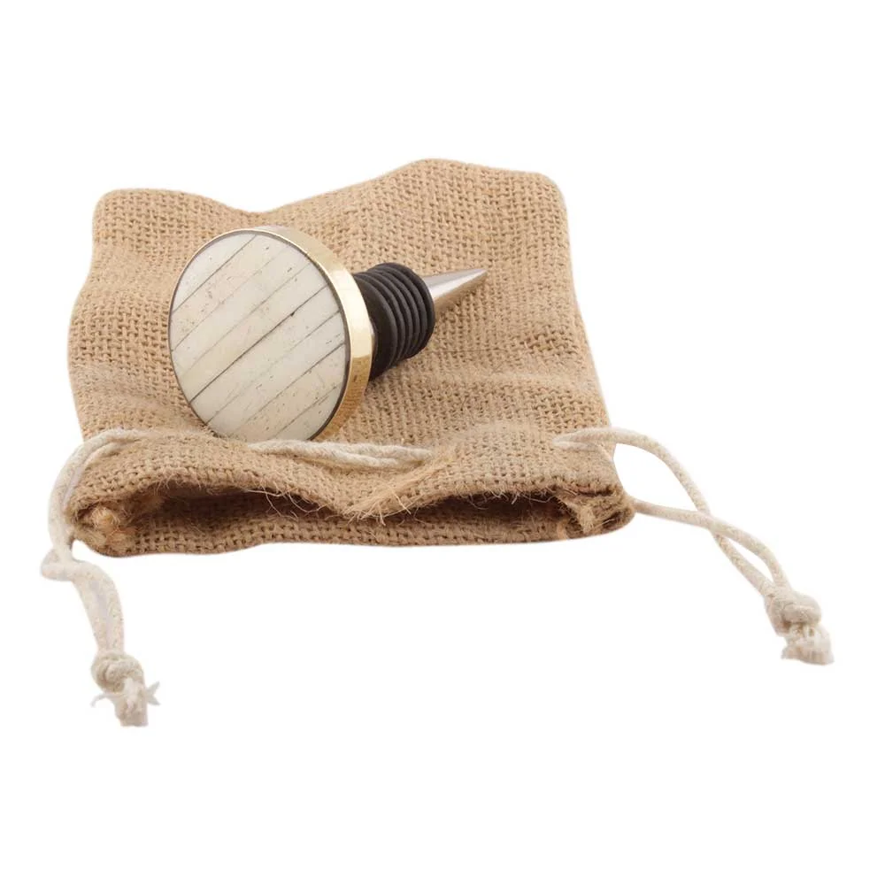 Bottlestopper Cream Metal and Bone on satchel.JPG