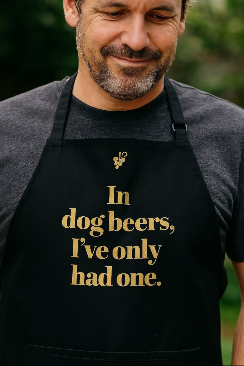 Close up view of Vinotopia apron with design: 'In Dog Beers I’ve Only Had One'.