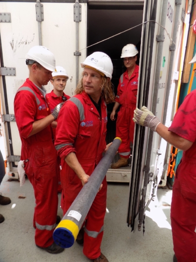 Behind these scientists is the refrigerated container where the cores were stored on the ship.