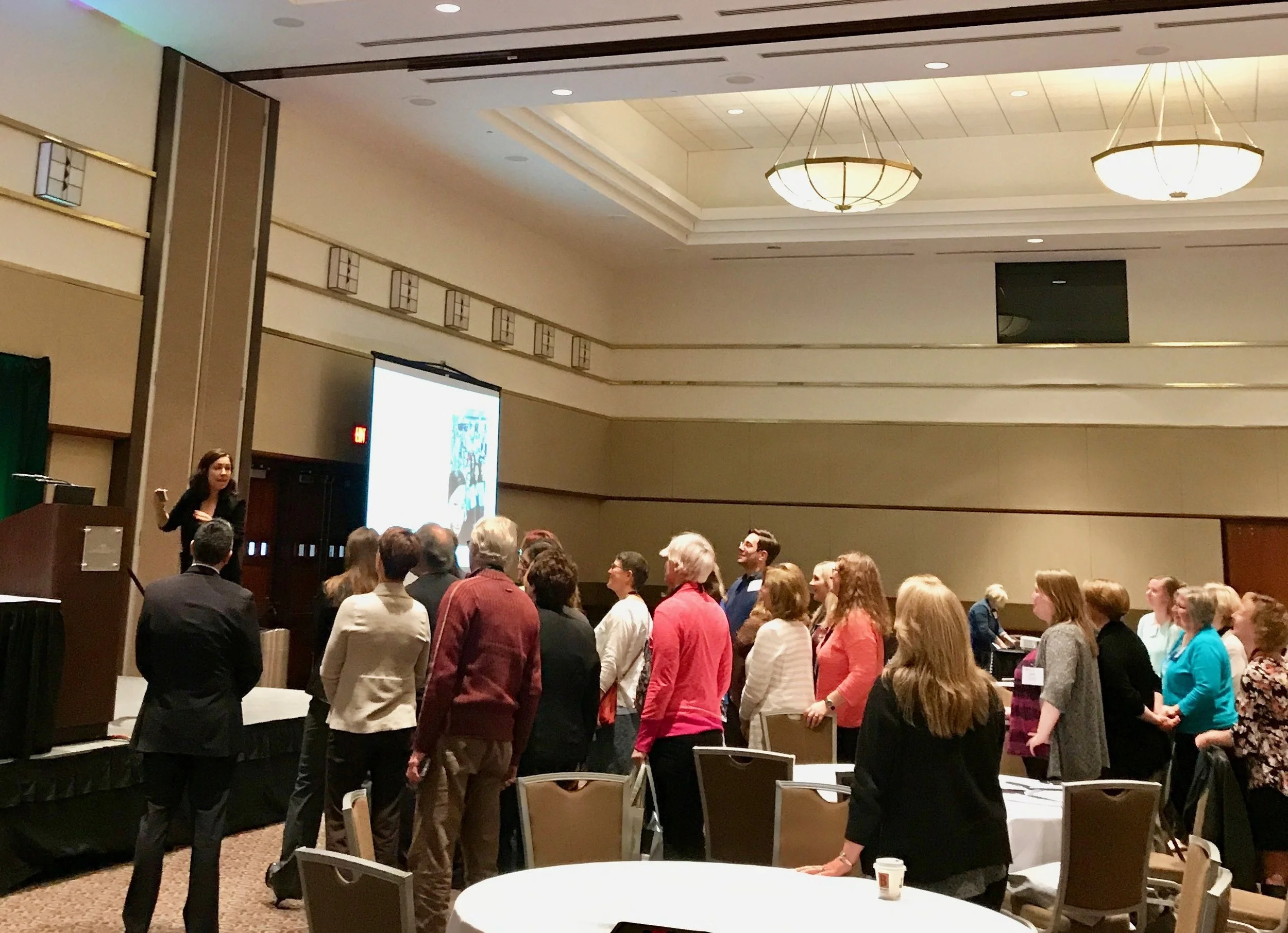 Manoush rallying the crowd for a selfie at the Michigan Library Association conference, in Lansing, MI. during her October book tour.