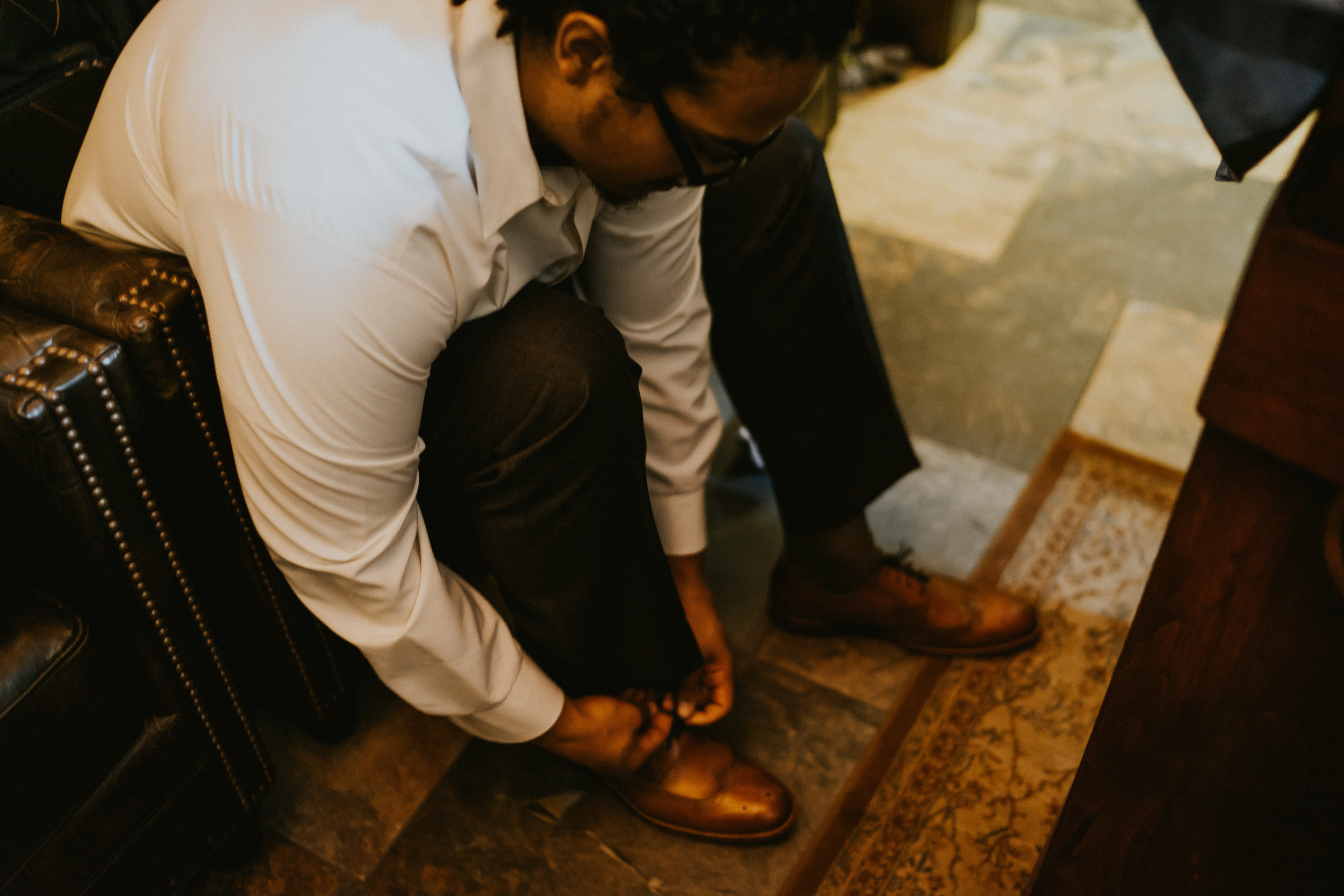 Groom shoes getting ready