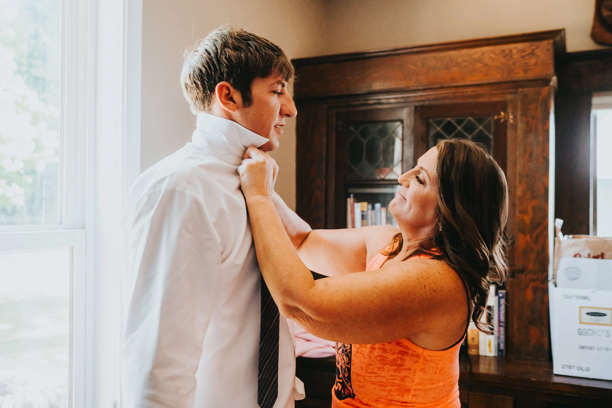 Groom bride's mother help tie getting ready wedding Columbia River private family backyard