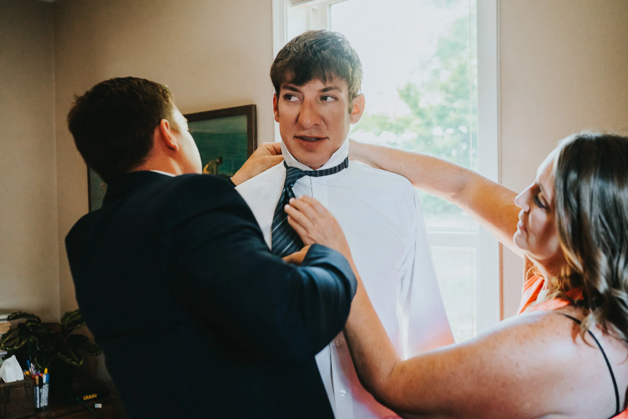 mother son getting ready tie window light wedding photographer Portland Oregon
