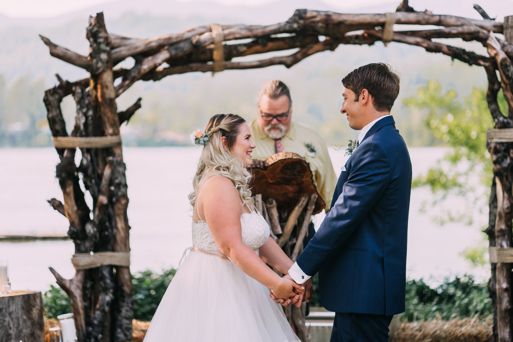 bride smile hold groom's hand ceremony Oregon Portland Wedding Photographer