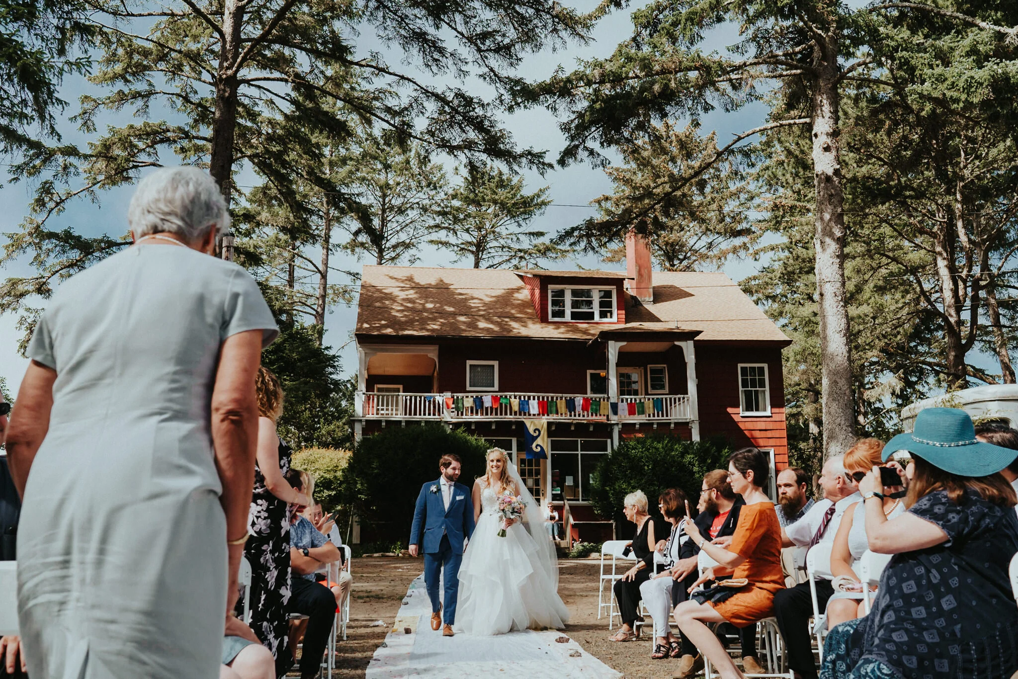 Bride groom look at each other down aisle Sou'Wester wedding photographer Alfred Tang
