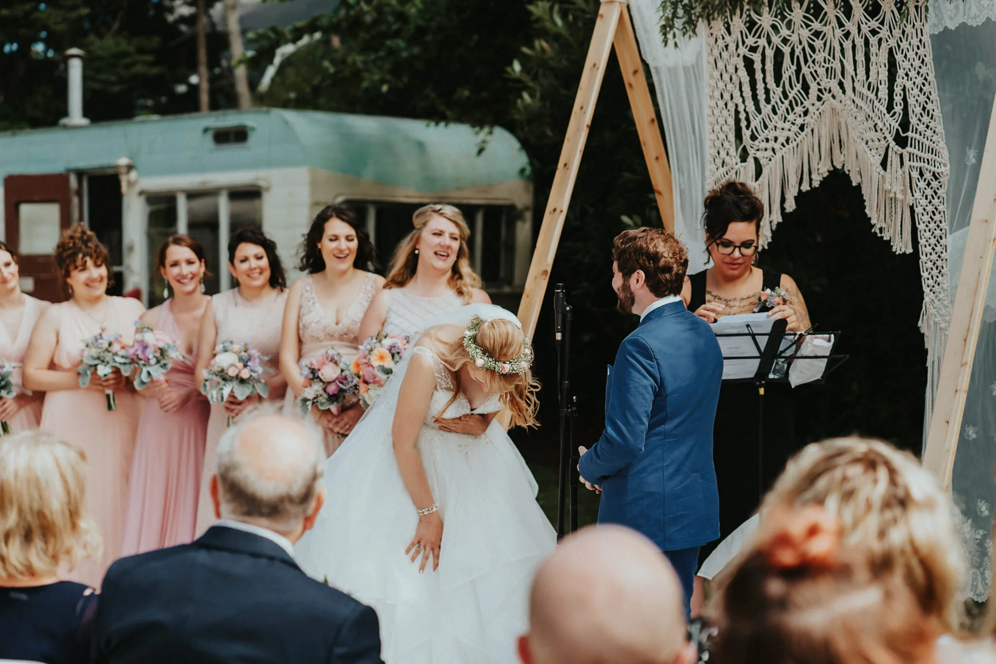Bride kneel over laughing groom vow candid wedding photographer Alfred Tang