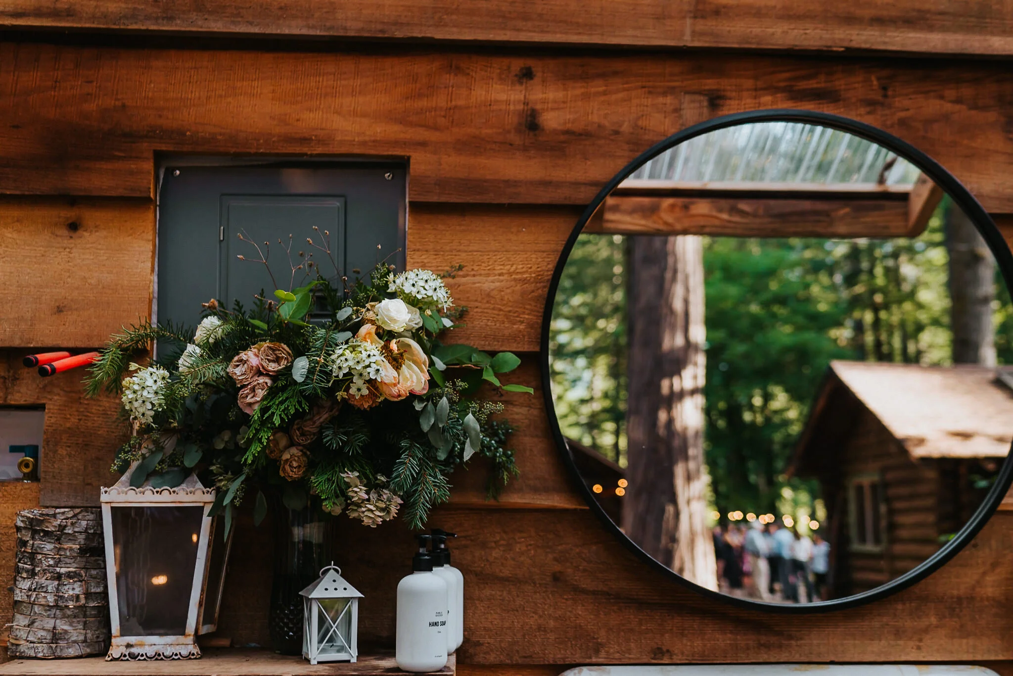 Flowers in vase with guests reflection in the mirror at Loloma Lodge