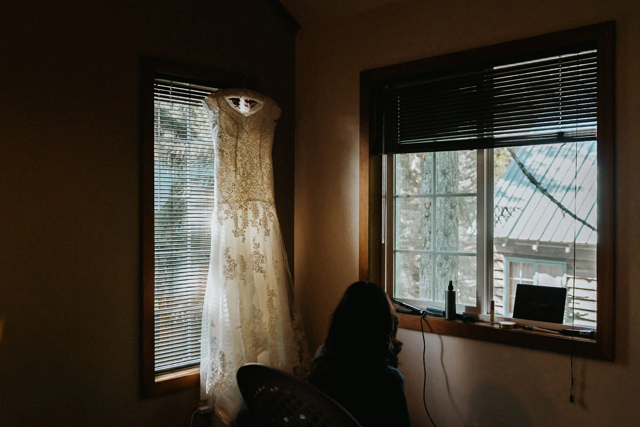Wedding Dress hangs on a window frame