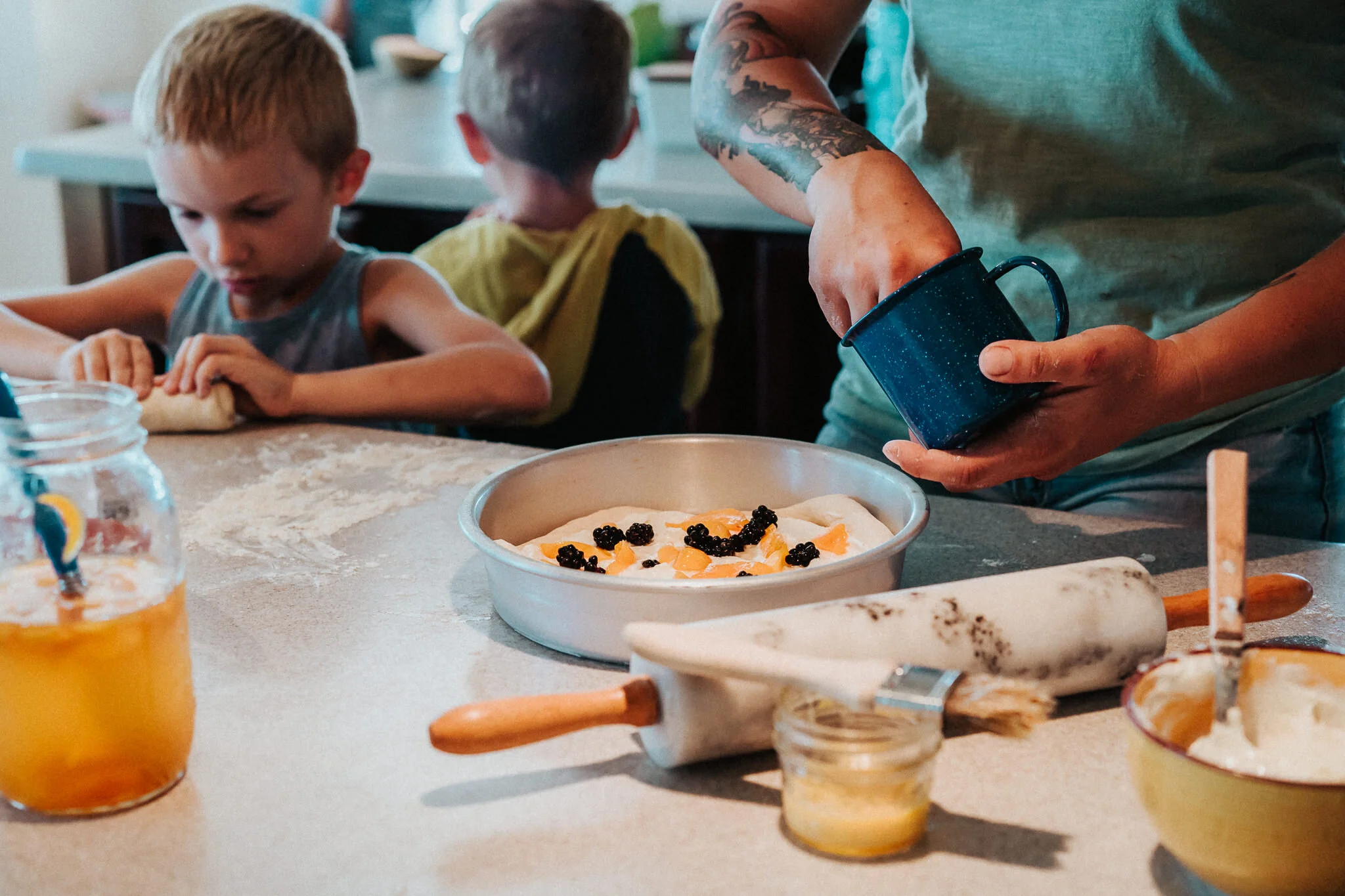 Placing more blackberries into the Kuchen.
