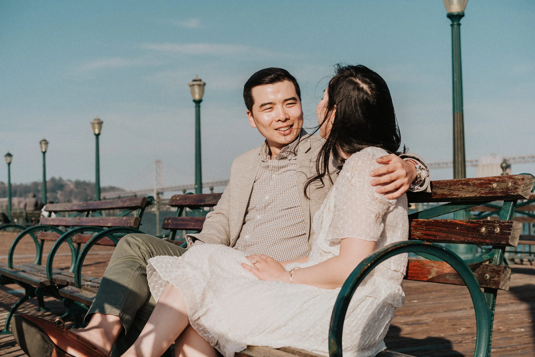 Sitting at the bench at San Francisco Pier Engagement Shoot