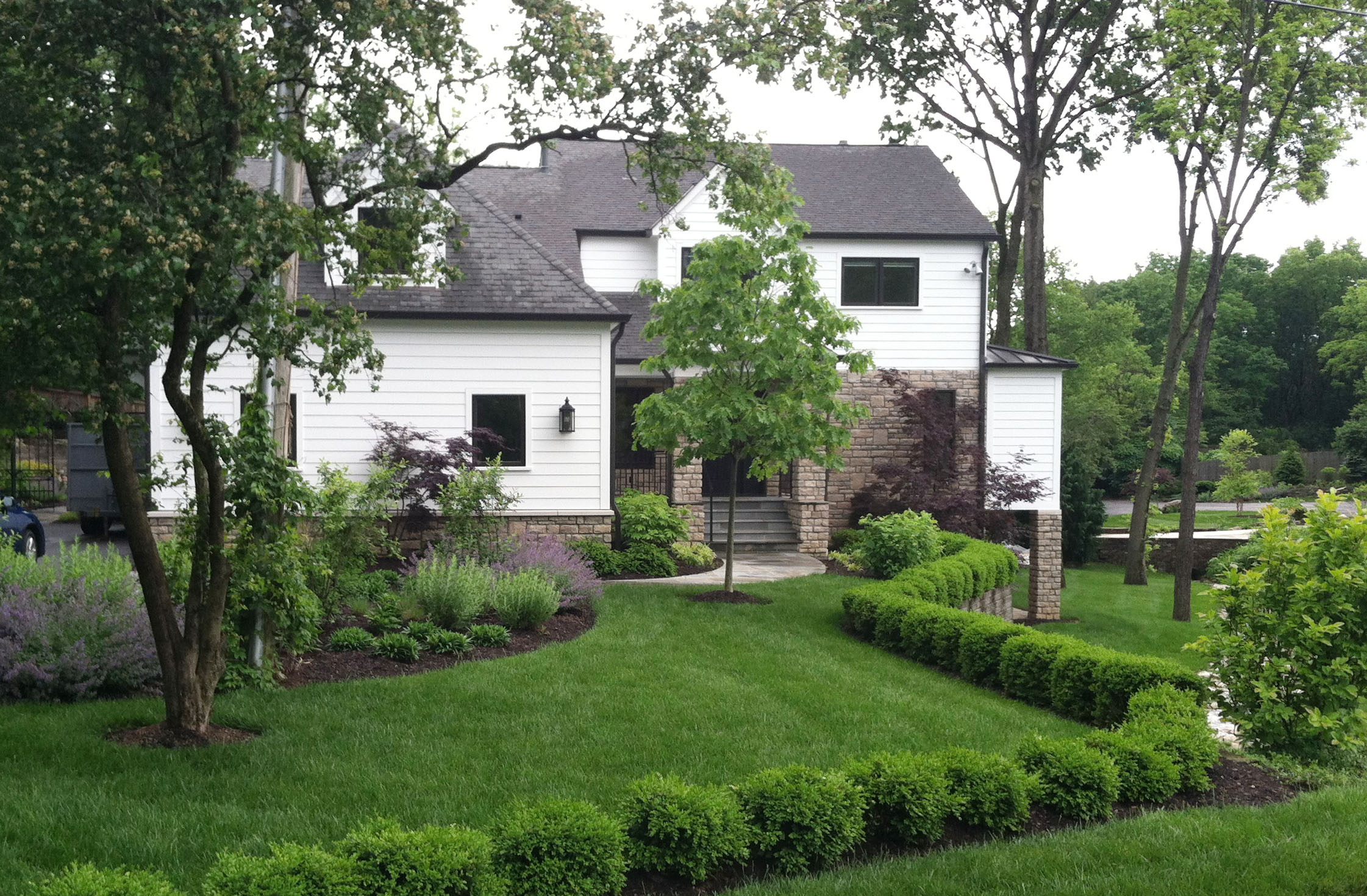 front landscape with boxwood hedge.png