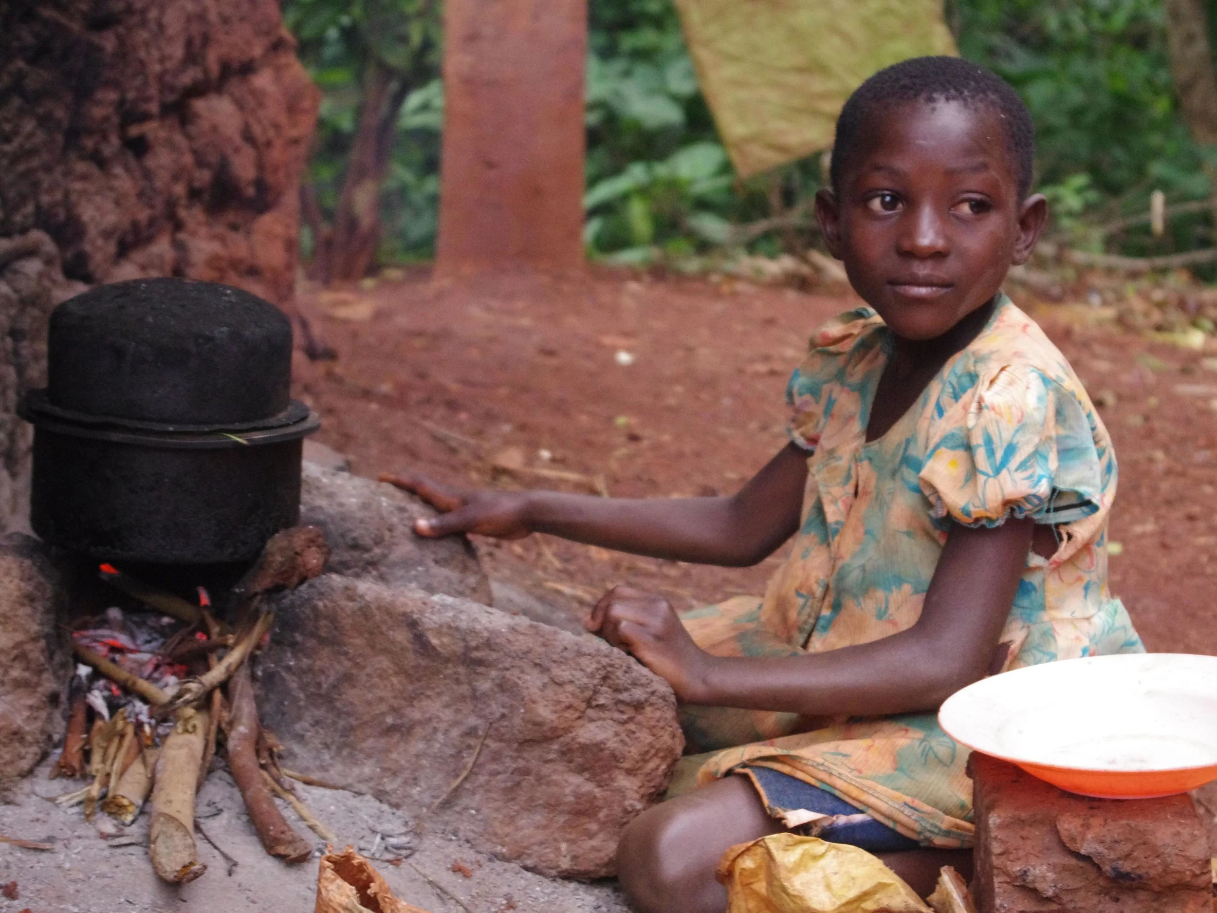 'Tasha, Age 8, Cooking For Her Family' by Paul Kawaga McKenzie