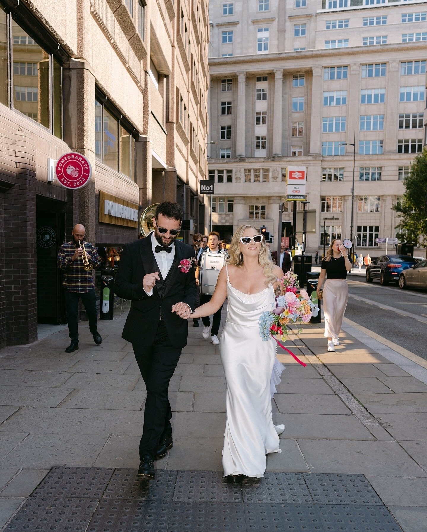 Beth + Toms colourful , Liverpool city wedding was an absolute Vibe!. 
.
Brass band - @hardcorehorns 
Ceremony @liverpooltownhall .
Reception @onefinewedding_liv .
Event styling and florals @theeventedituk .
Dress designer - @watters .
Dress shop - @