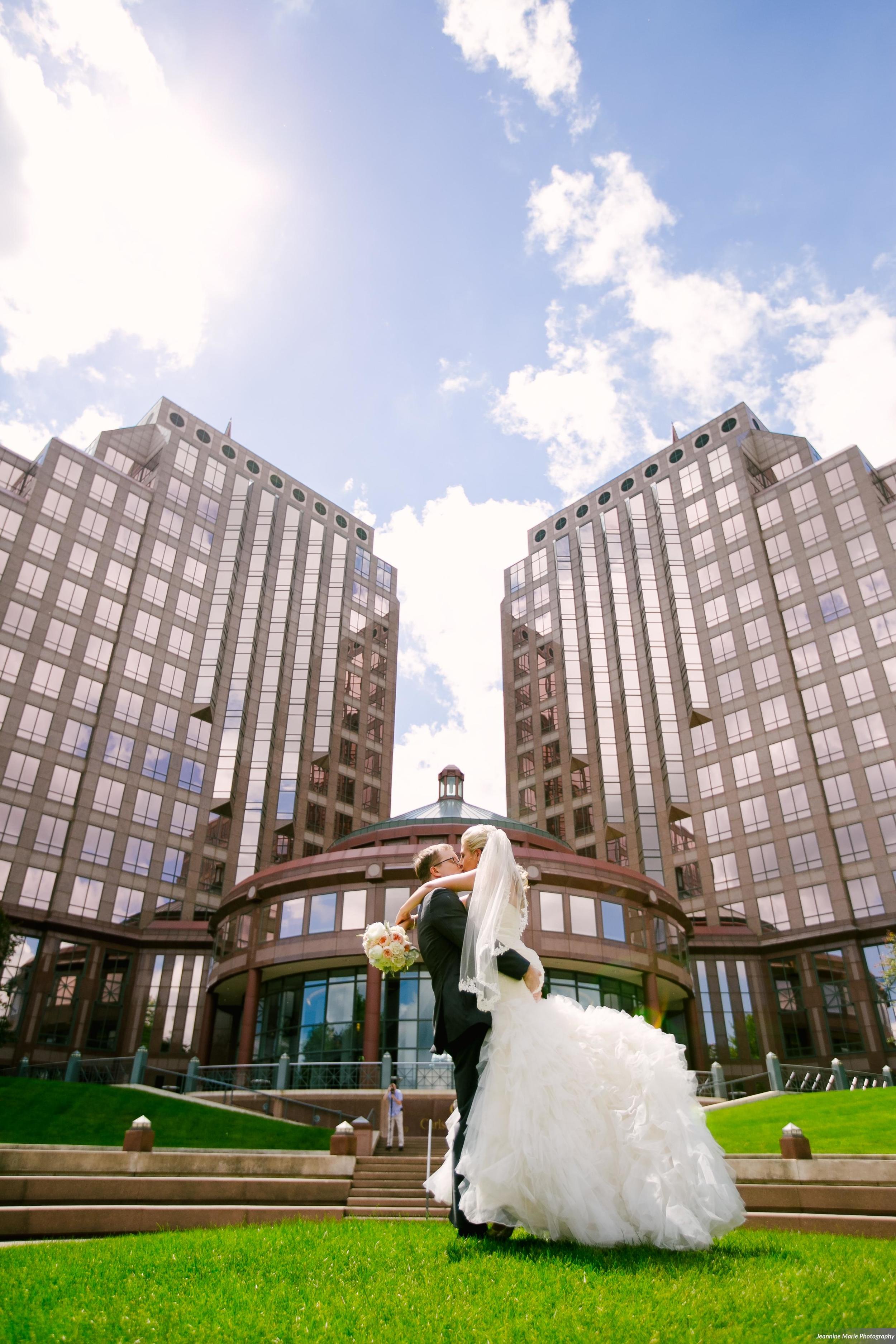 Photographer: Jeannine Marie Photography | Event Venue: The Carlson Towers Rotunda and Amphitheatre | Caterer: Bon Appetit at Carlson Center | Floral & Event Designer: W himsy Designs | Event Planner: Emily, The Simply Elegant Group | Cinema and Video: J Walter Anderson Photo and Video | Cake Designer: Queen of Cakes | Hair Stylist: Sanctuary Salonspa | Makeup Artist: Sanctuary Salonspa | Tuxedo and Mens Attire: Savvi Formalwear | Dress Designer: Stella York | Dress Store: Charlotte’s Bridal | Officiant: Grand Avenue Wedding Officiants | Other: International Cigars | Photo Booth Equipment: The Photo Booth Group | Invitation Designer: Wedding Paper Divas | DJ: Adagio Djay Entertainment