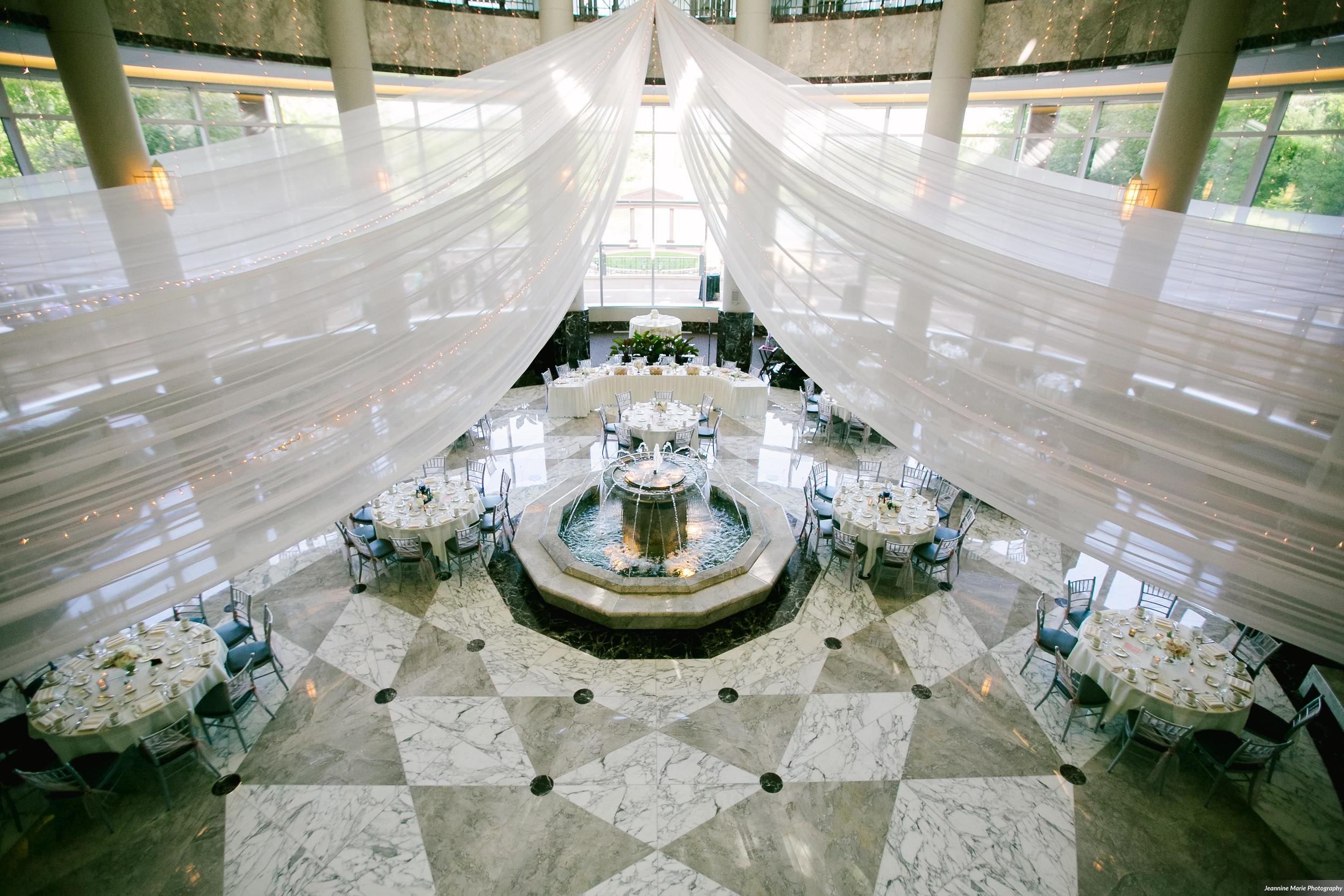 Photographer: Jeannine Marie Photography | Event Venue: The Carlson Towers Rotunda and Amphitheatre | Caterer: Bon Appetit at Carlson Center | Floral & Event Designer: W himsy Designs | Event Planner: Emily, The Simply Elegant Group | Cinema and Video: J Walter Anderson Photo and Video | Cake Designer: Queen of Cakes | Hair Stylist: Sanctuary Salonspa | Makeup Artist: Sanctuary Salonspa | Tuxedo and Mens Attire: Savvi Formalwear | Dress Designer: Stella York | Dress Store: Charlotte’s Bridal | Officiant: Grand Avenue Wedding Officiants | Other: International Cigars | Photo Booth Equipment: The Photo Booth Group | Invitation Designer: Wedding Paper Divas | DJ: Adagio Djay Entertainment