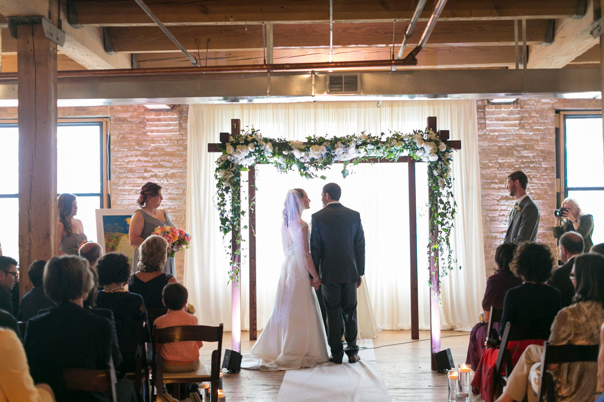 Vendors: Planner: Ashley C. – Simply Elegant Group | Photography: Wakefield Photo | Hair/Makeup: Bev Esquivel – with Kate Johnson Artistry | Venue: Lacuna Artist Lofts | Florist: Victoria Claus – AEG Productions | Caterer: LM Catering | Cake: Sweet Mandy B’s | Ceremony Music: Alex Sokol / Common Knowledge| DJ: Style Matters | Lighting: SC Lighting Design | Photobooth: Traveling Photo Booth | Transportation: Second City Trolley