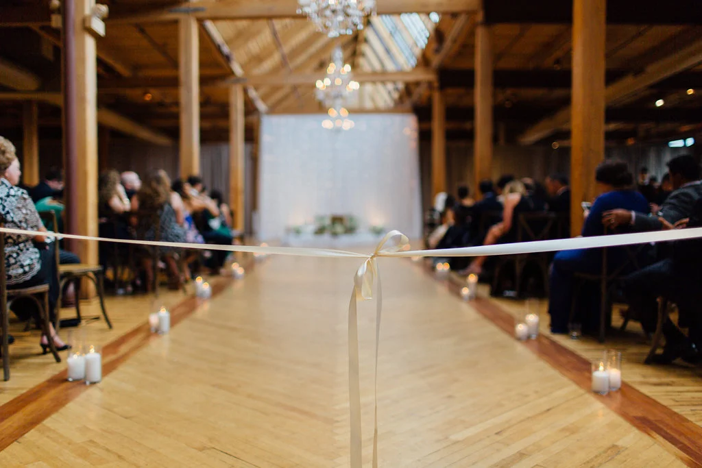 Photography: Tim Tab Studios | Coordination: The Simply Elegant Group, Lindsay | Floral design: The Bread and Butterfly | Decor: Art of Imagination | Hair: Holli Beauty | Makeup: Joanna B Artistry and Anjelica Bannos | Bride’s gown: Sarah Seven | Groom's tux: The Black Tux | Bridesmaids: Show Me Your MuMu | Venue: Bridgeport Art Center | Catering: Limelight Catering