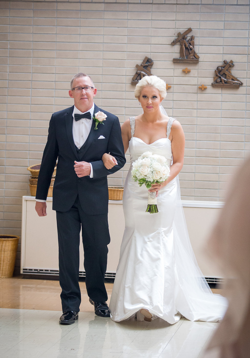 Bride walking down the aisle with Father for church wedding