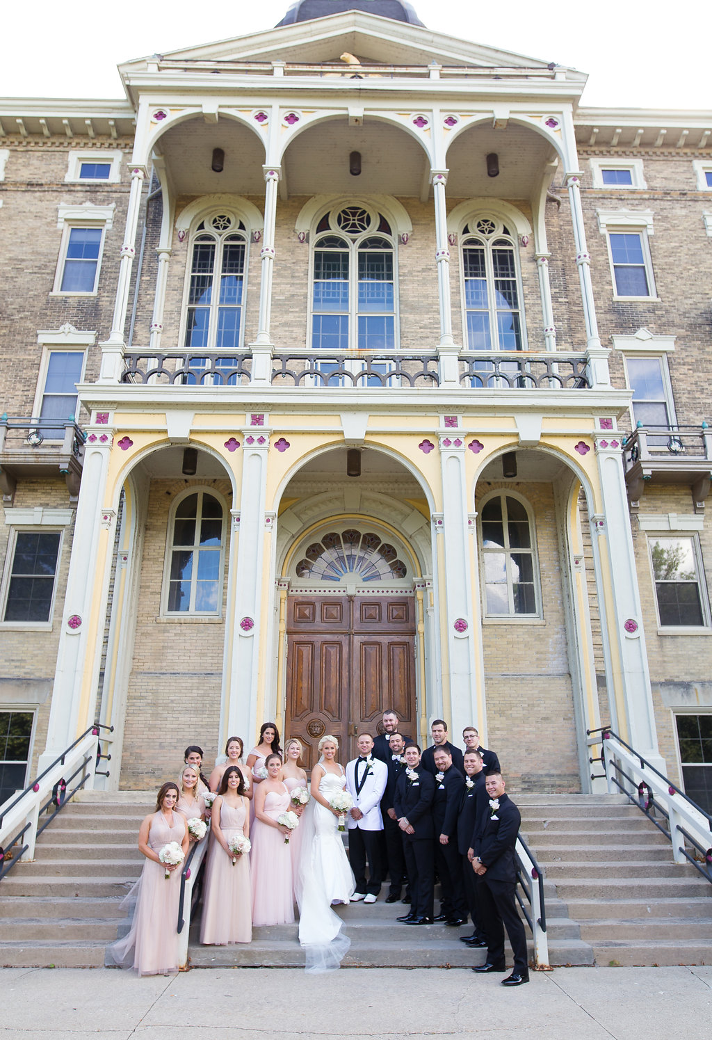 Bride and Groom with bridal party outside of church in Milwaukee, Wisconsin