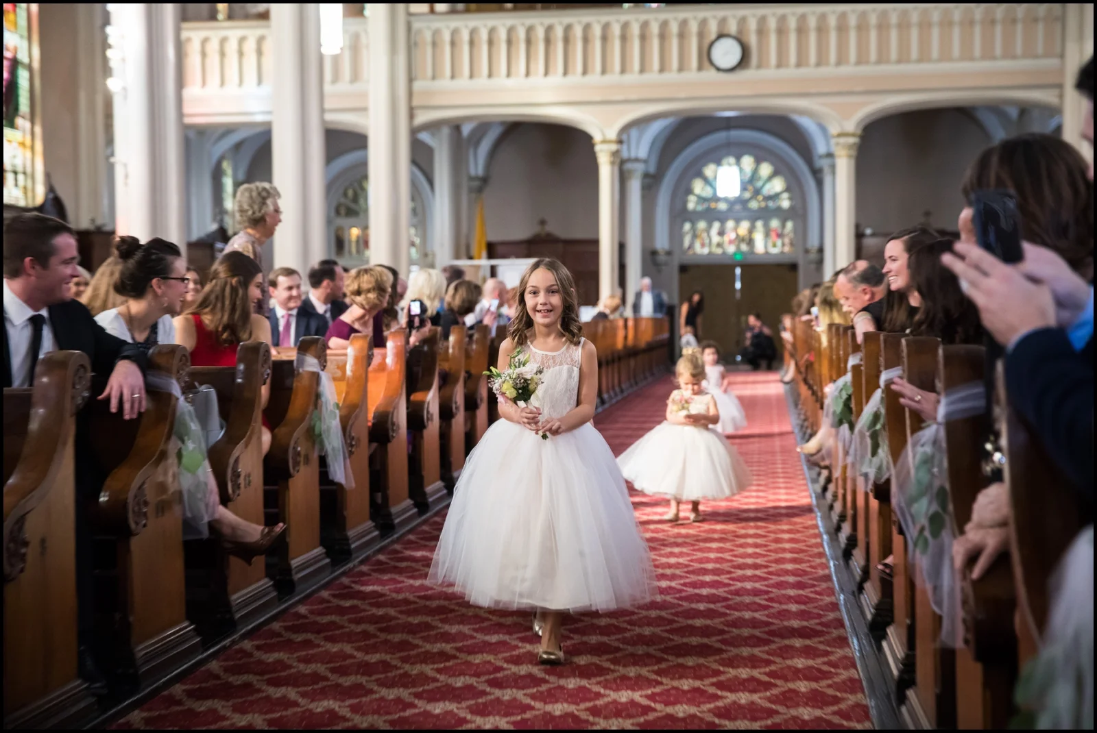 flower girls walking down the aisle
