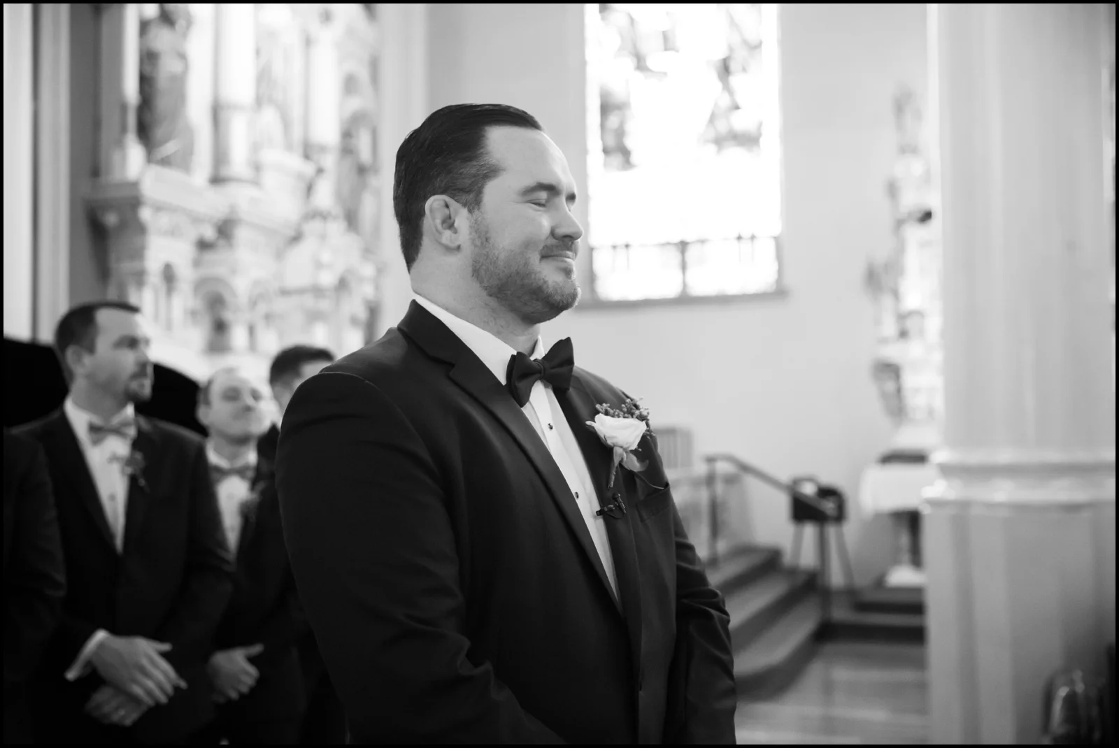 groom gazing at his bride walking towards him