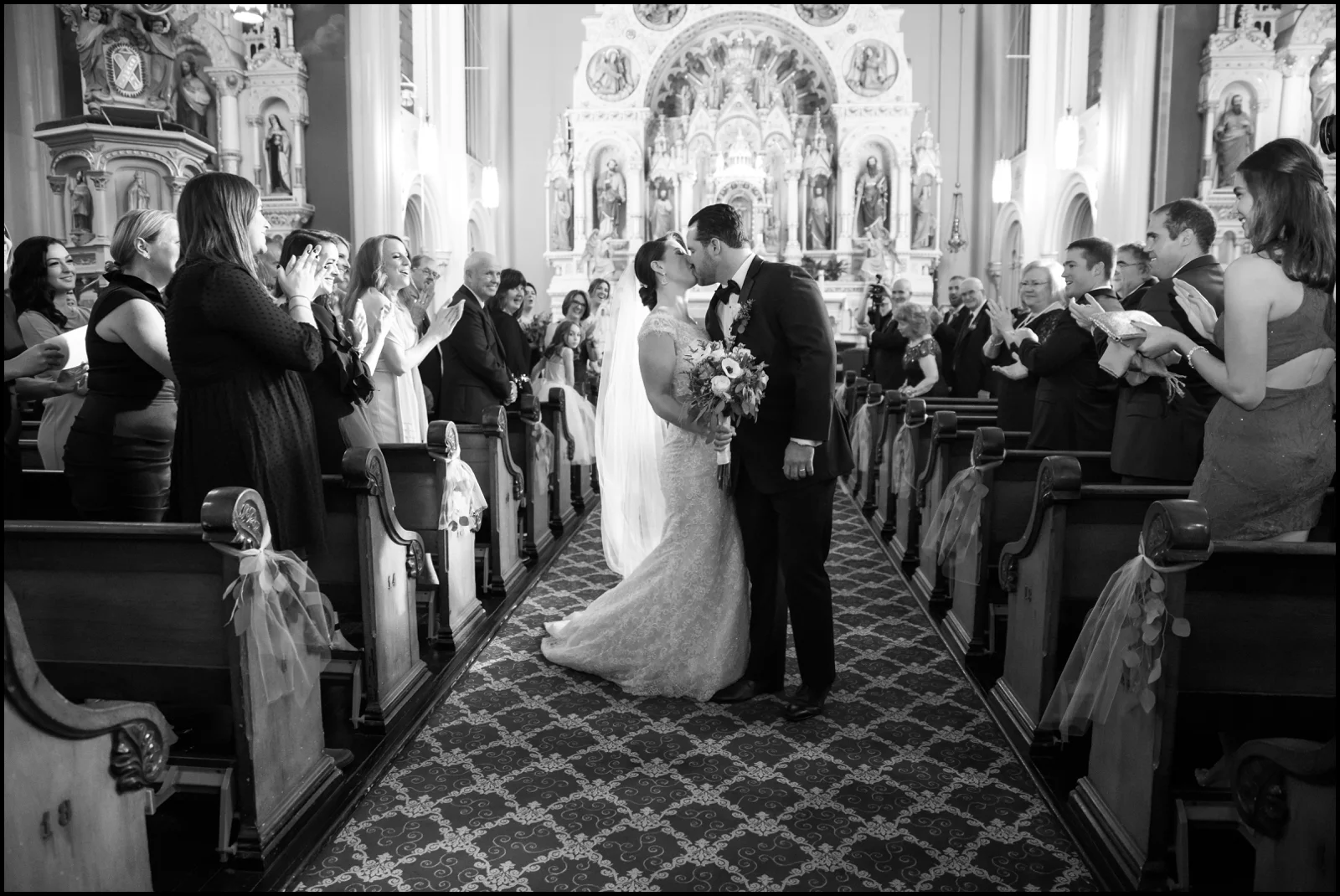 bride and groom kiss at ceremony