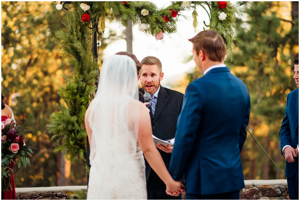 bride and groom holding hands at their wedding ceremony