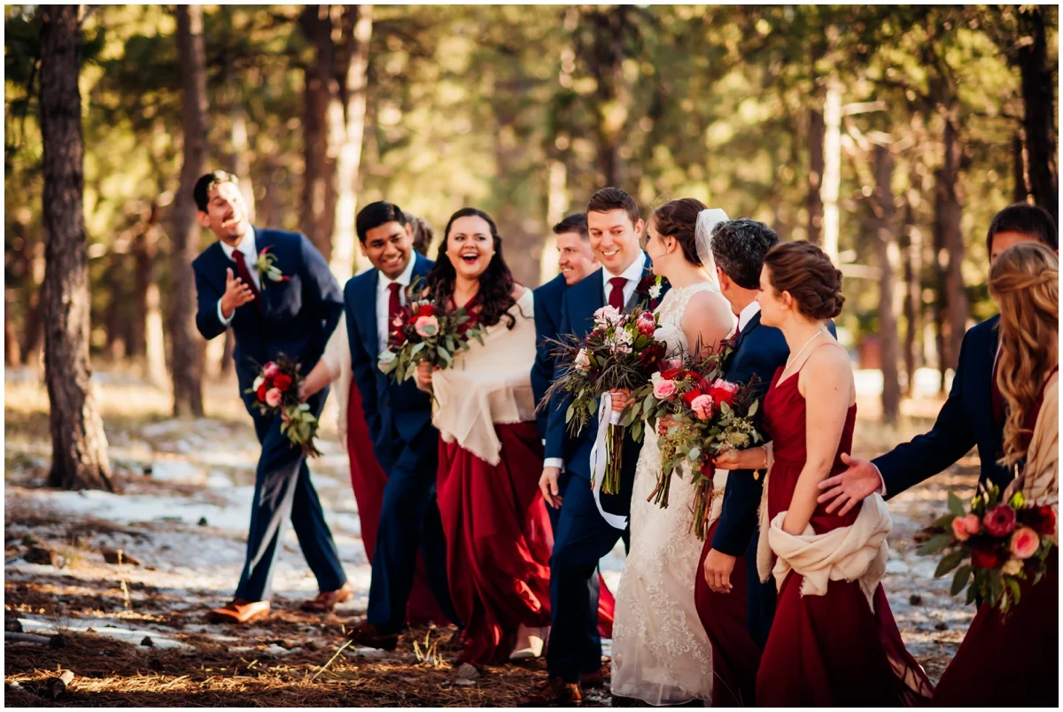 bridal party walking in the woods together