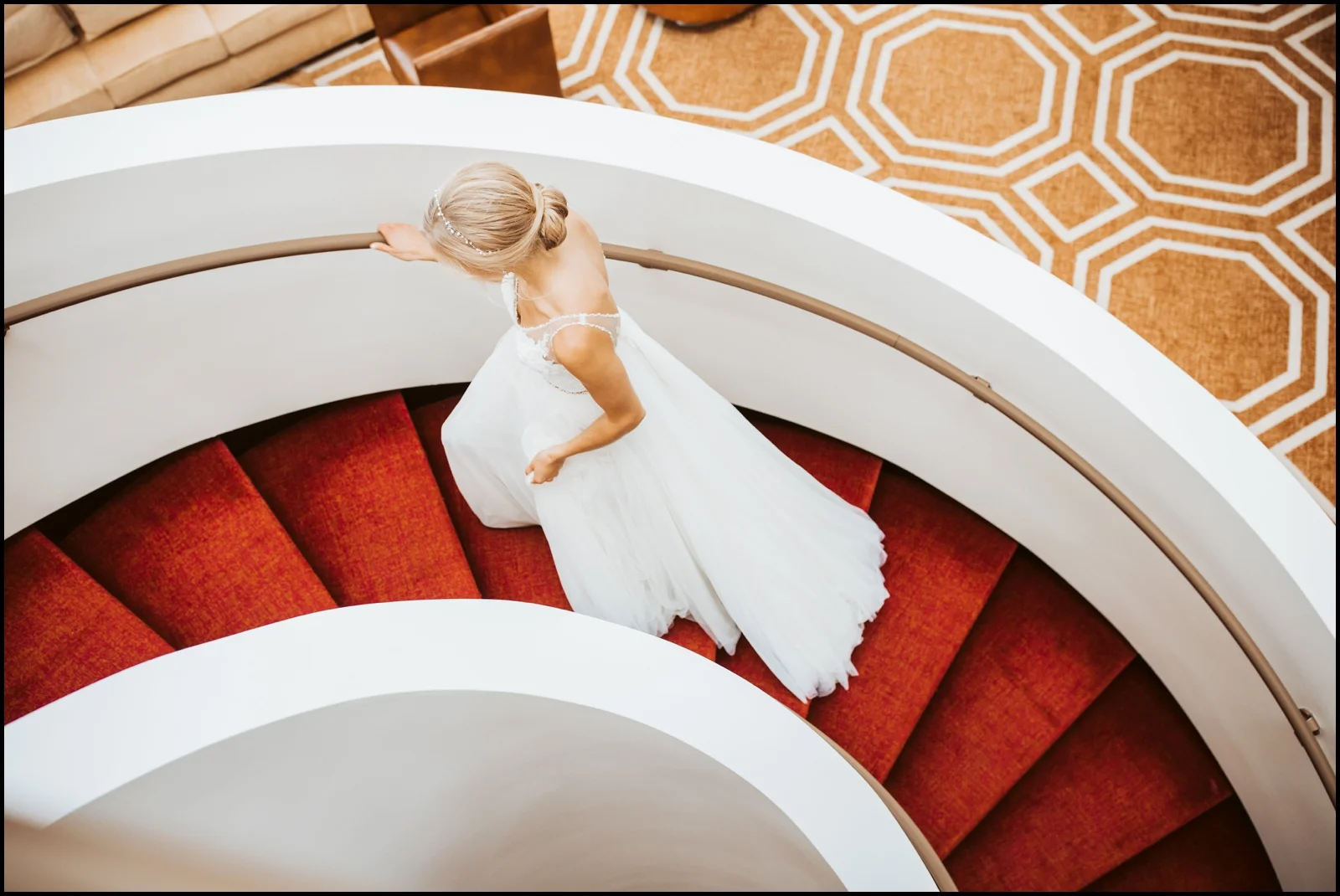 Bride walking up some red stairwell
