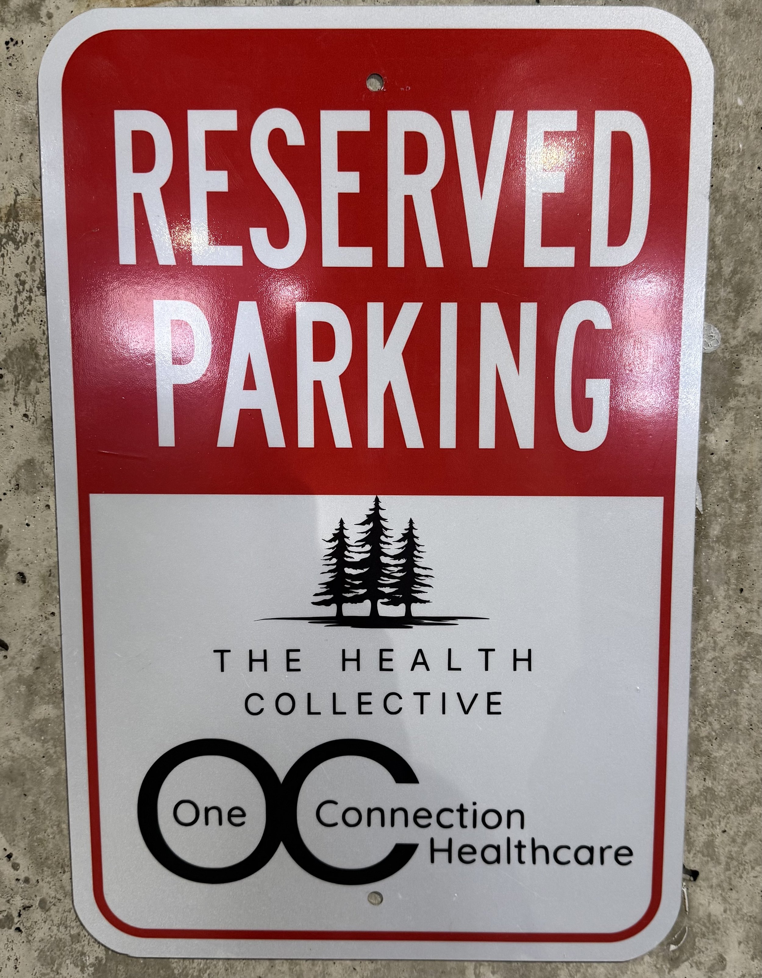 parking placard reads "reserved parking. The health collective. One connection healthcare)