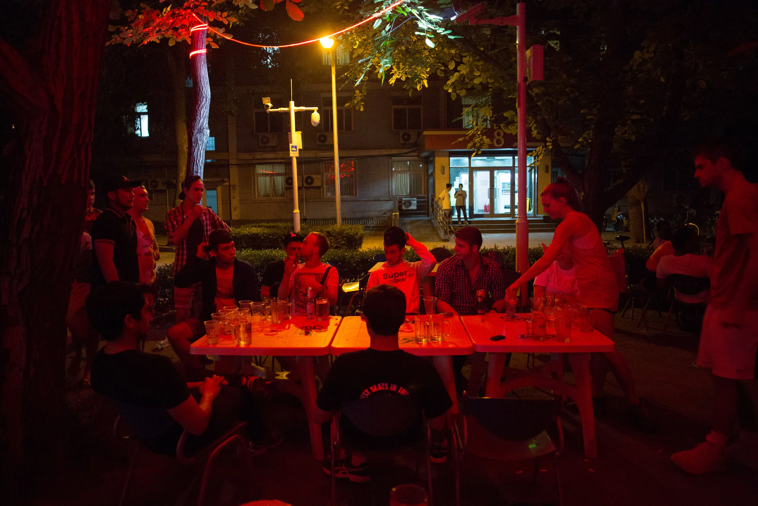 In the "beer garden" at Beijing Language and Culture University, one of the most famous Chinese language schools for foreigners in the country, a mixture of predominantly Russian and American students play a drinking game late into the night. With a