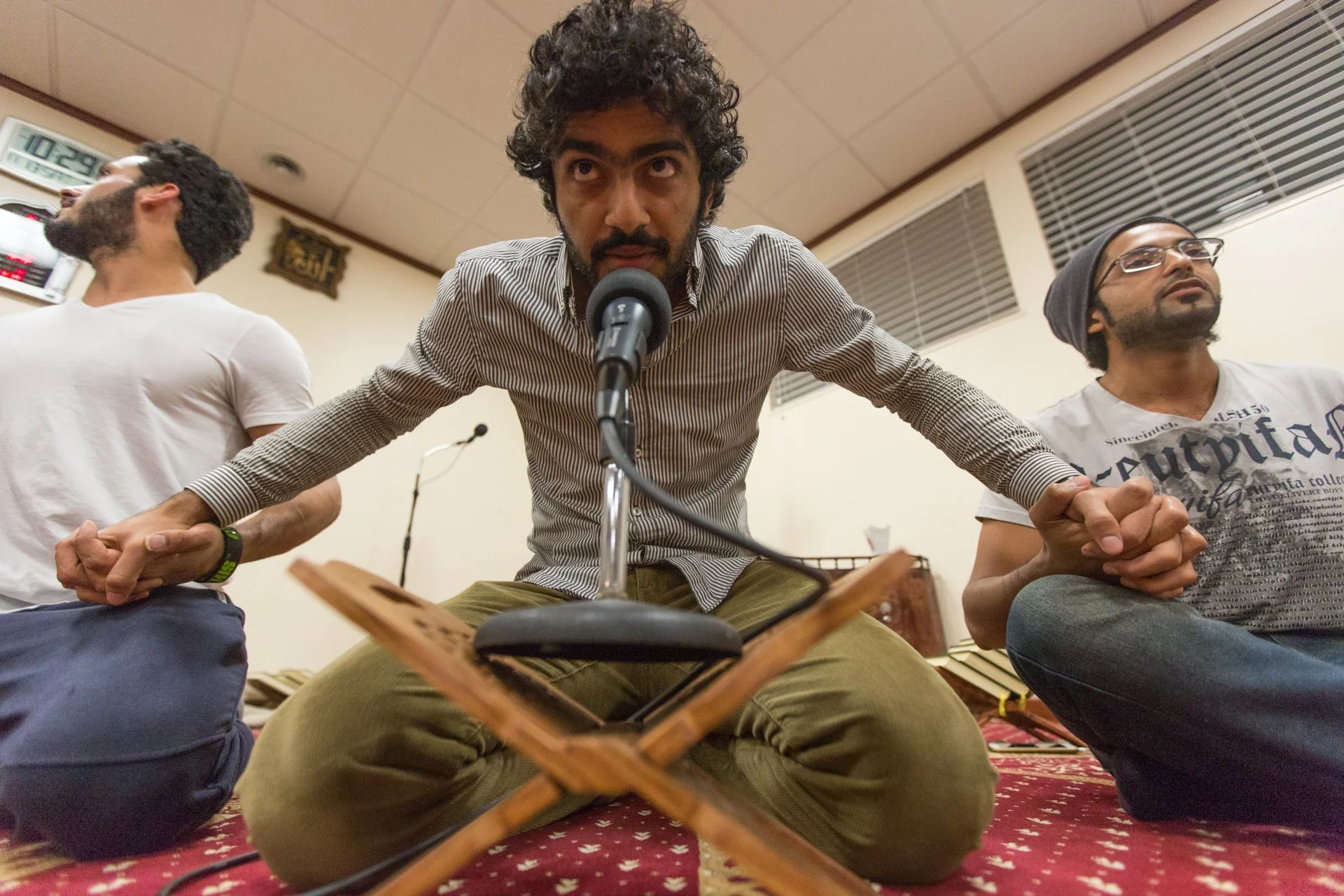  Ali Al Balushi (center), an Omani student at Ohio University, leads a group activity during Friday evening dinner on November 12, 2015, and hold hands with Naif Aldosari (left) and Ali Al Sairi (right), both of whom are Saudi students. The Muslim st