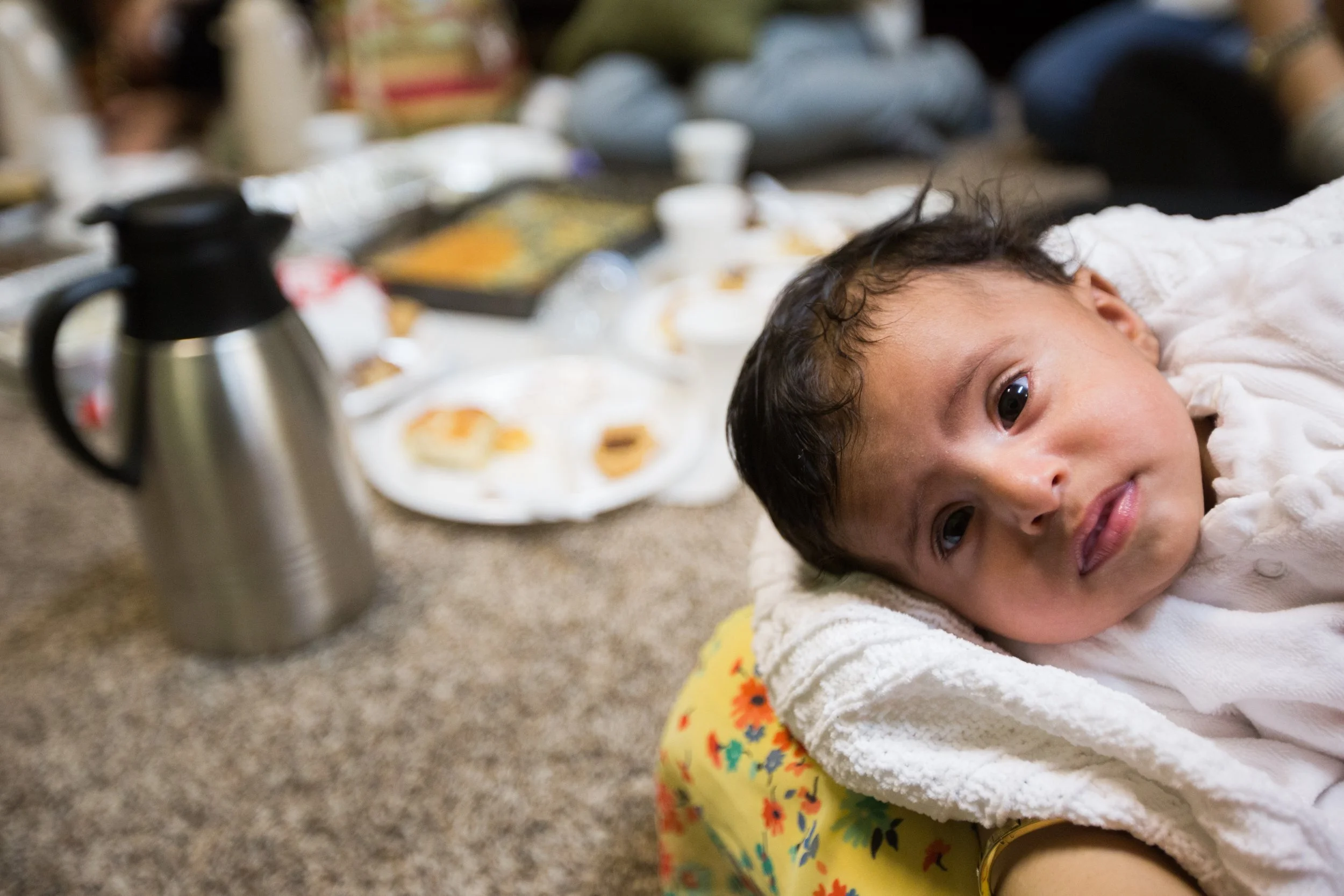  Sarah, 6 months old, is held by family friend, Mashel Al Dosari, during the women's Friday evening gathering on October 24, 2015, at the Islamic Center. The women, most of whom have husbands who participate in the center's program downstairs, while 