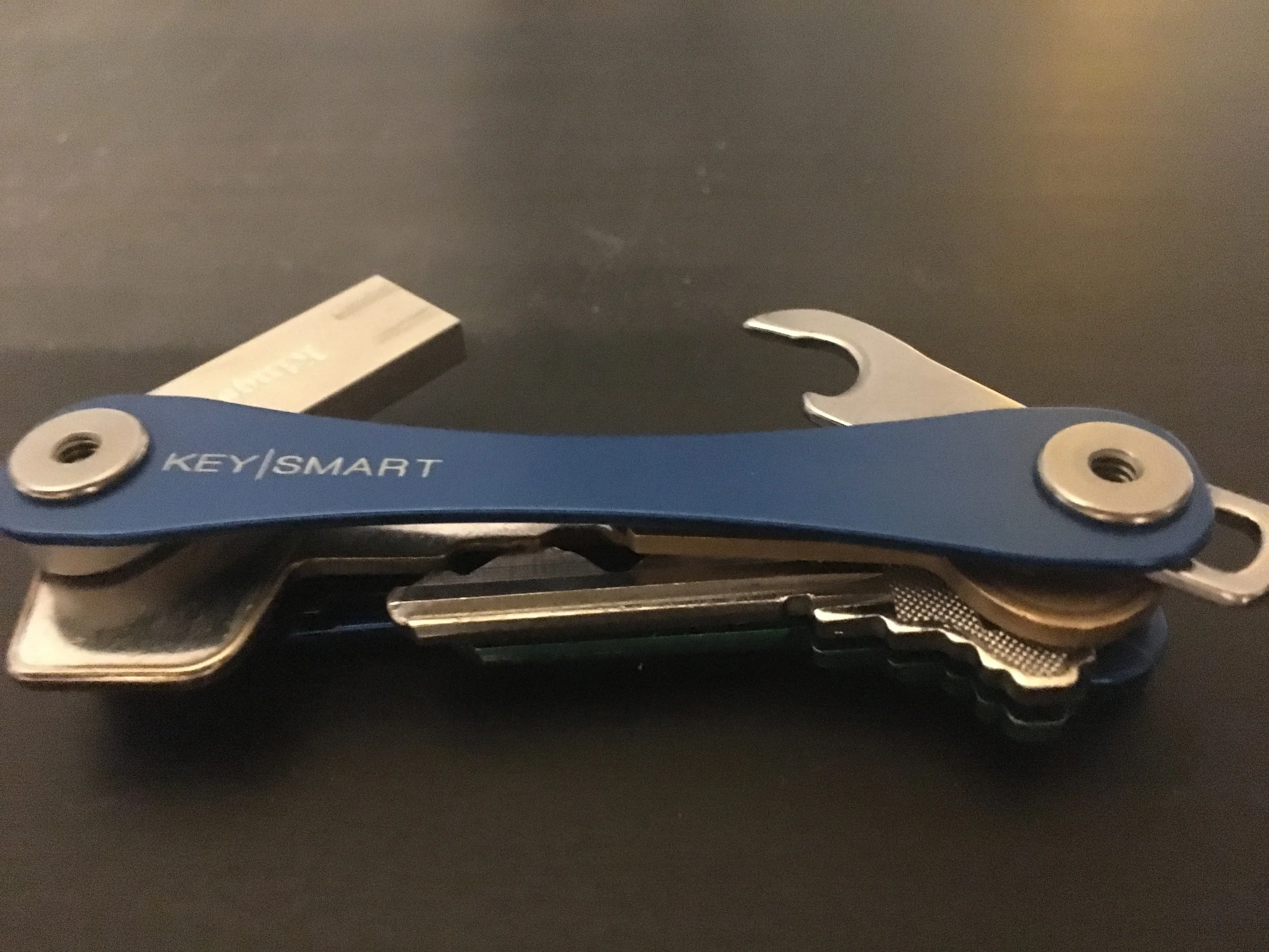 KeySmart Extended shown with the USB key (left) and the bottle opener (right)