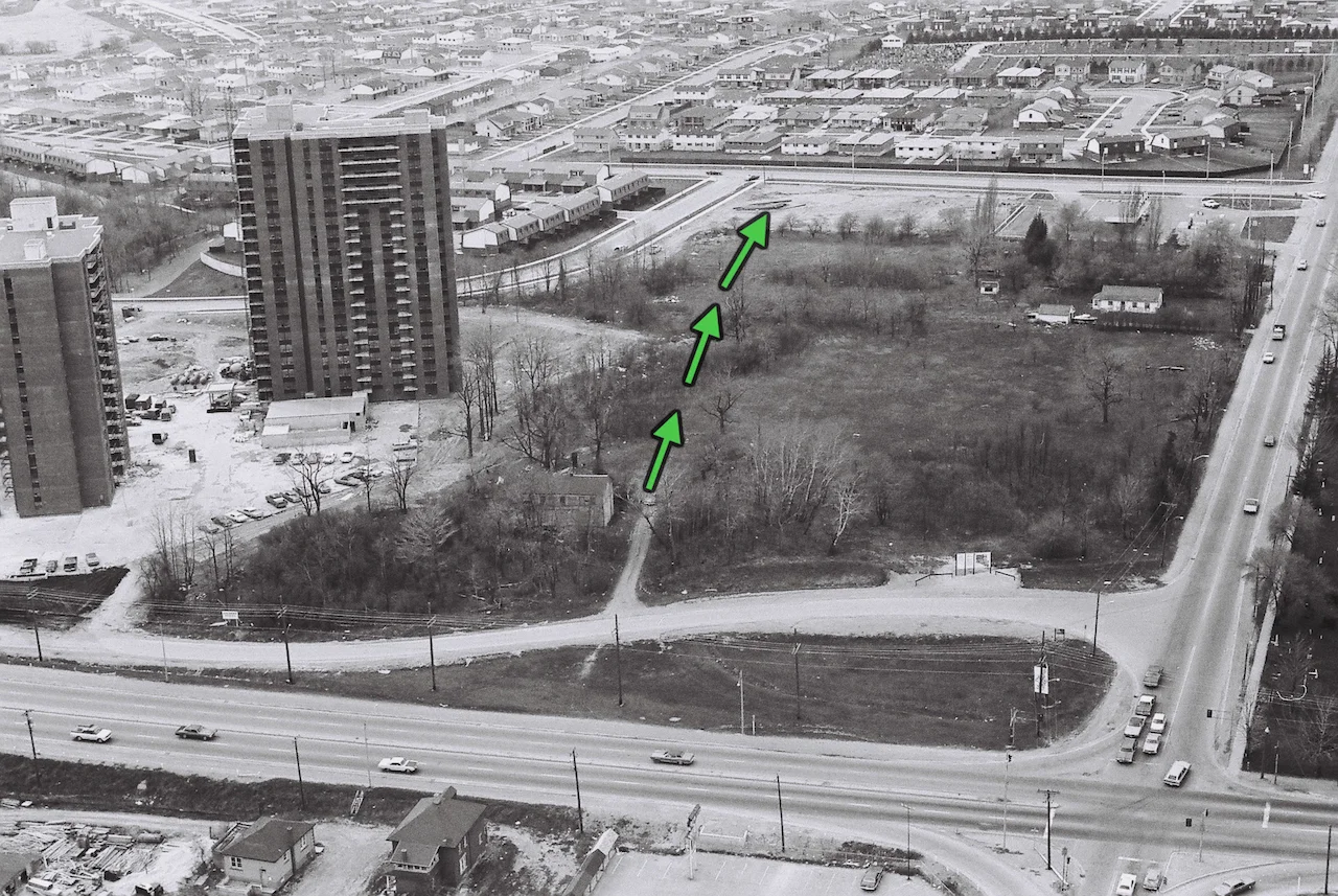 This aerial photo taken prior to the move shows the location of Cherry Hill and the 400 yards north journey through bush needed to re-locate the home to its new site. Note the sign at the bottom of the photo announcing the planned road re-alignment. The two apartment towers, a McLaughlin development, were under construction at the time. His Mississauga Valleys residential community to the north, was also nearing completion. 