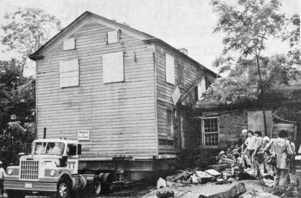 The home (without the stone foundation) sits on a flatbed truck ready for the move.