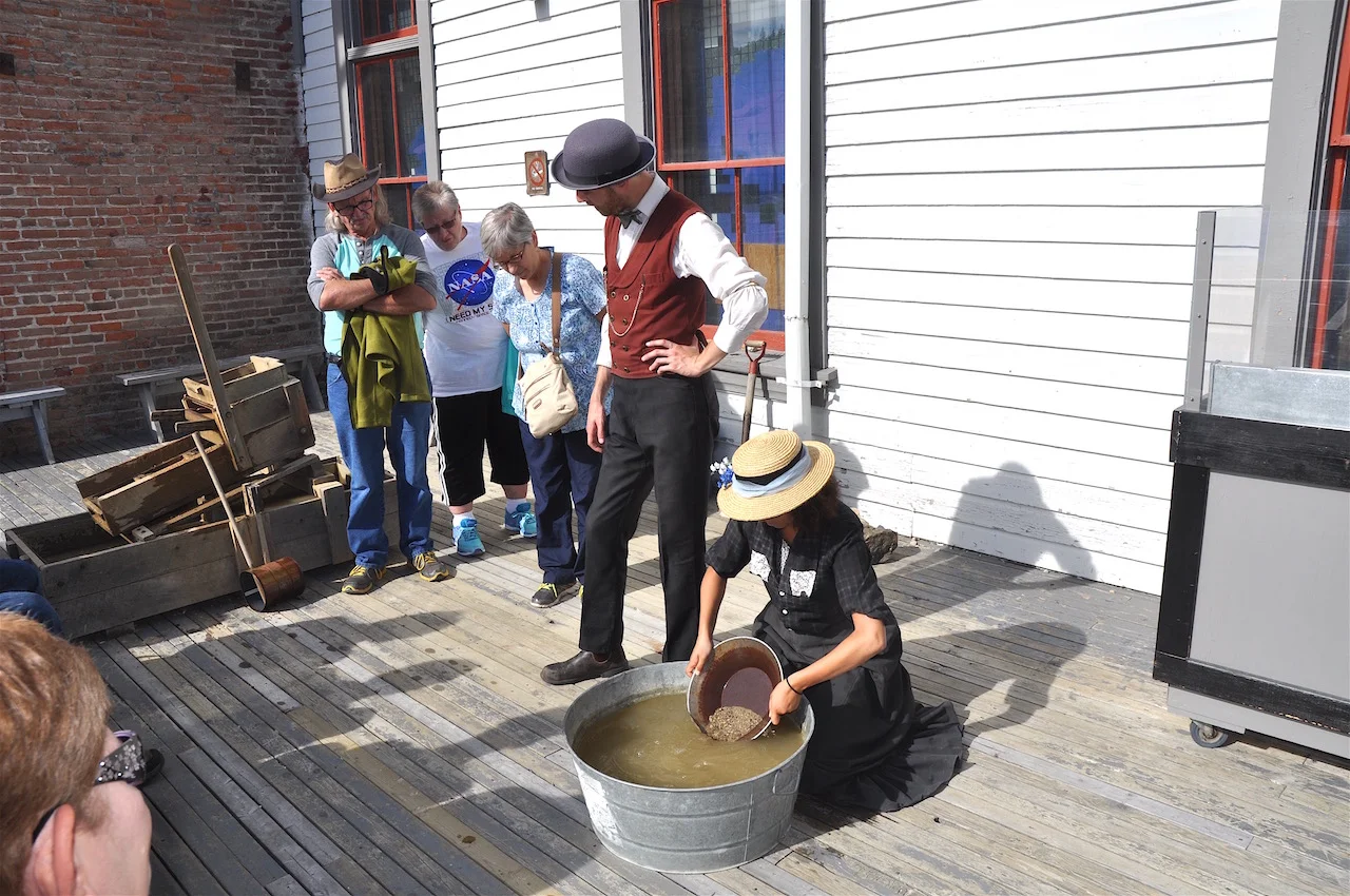 Parks Canada staff demonstrate the art of panning for gold.