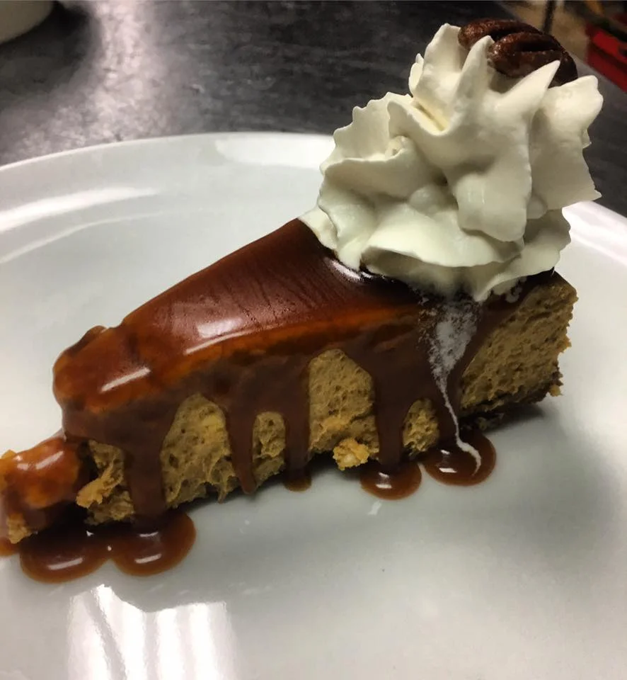 Pumpkin cheesecake with ginger snap crust, pumpkin spice roasted pecans caramel sauce and cream fraîche