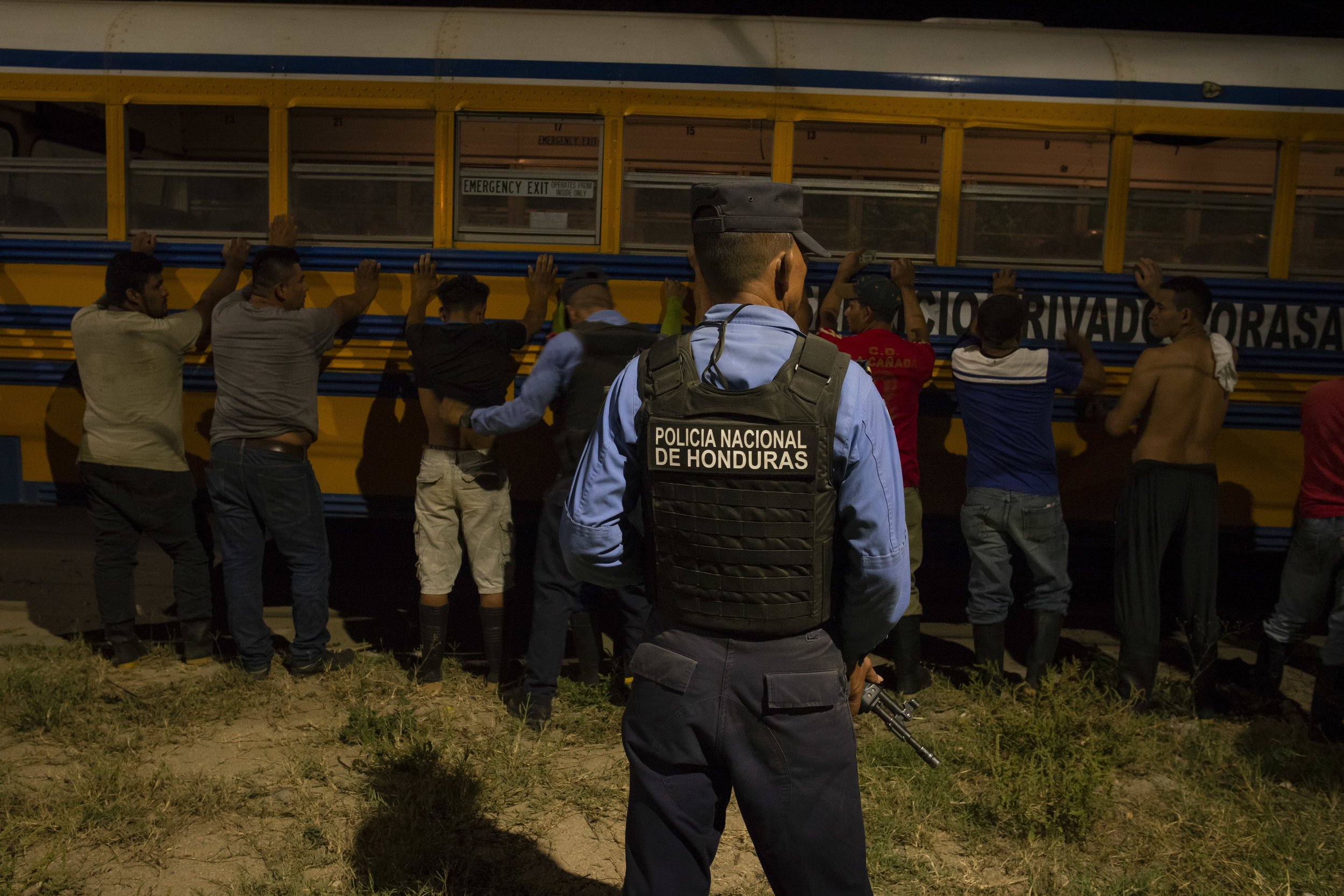  Police frisk and ID a bus full of men in Rivera Hernandez. San Pedro Sula, Honduras. 