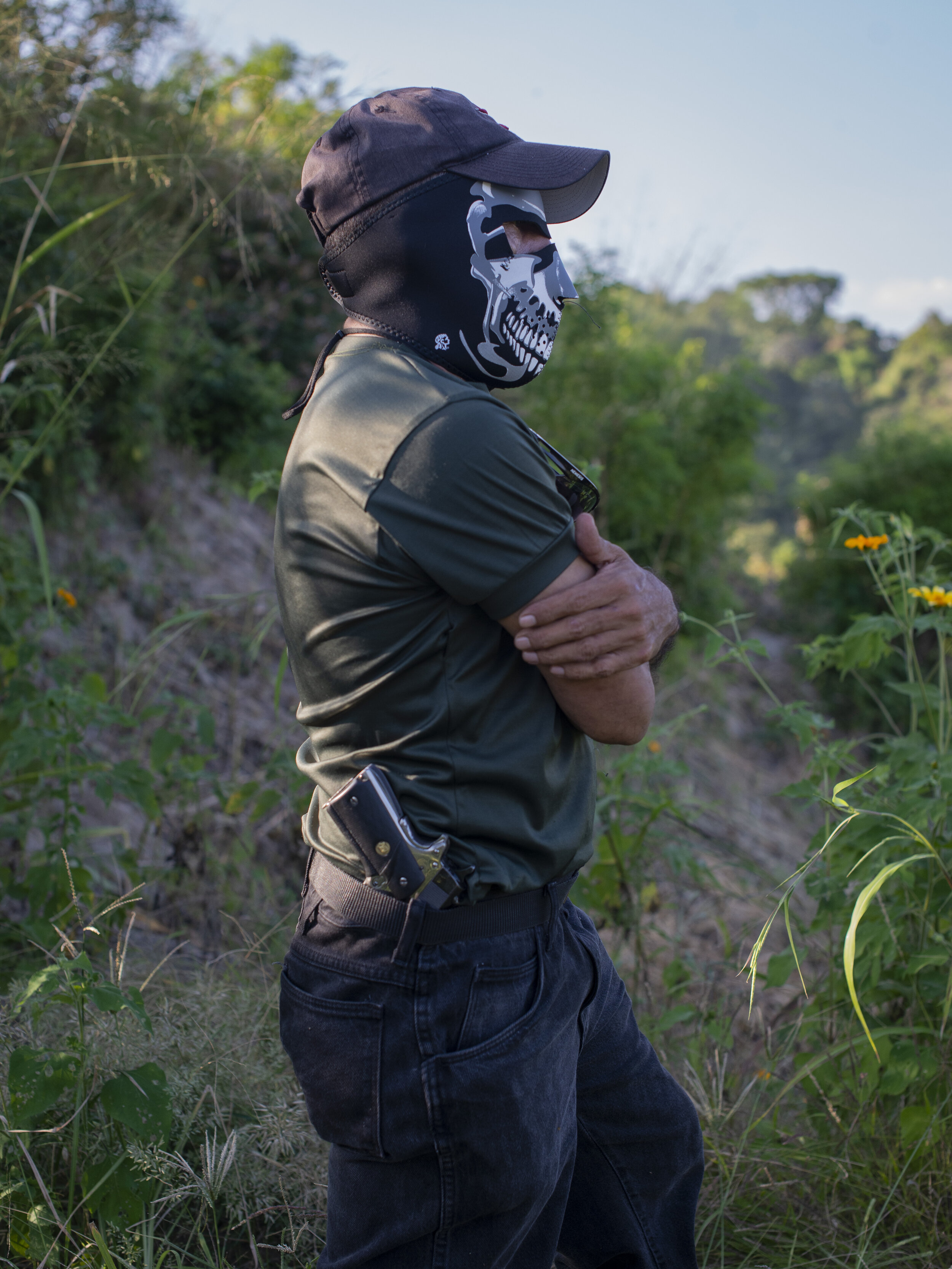  An armed civilian stands on patrol in the Anemona Community in San Martin just outside of San Salvador. 