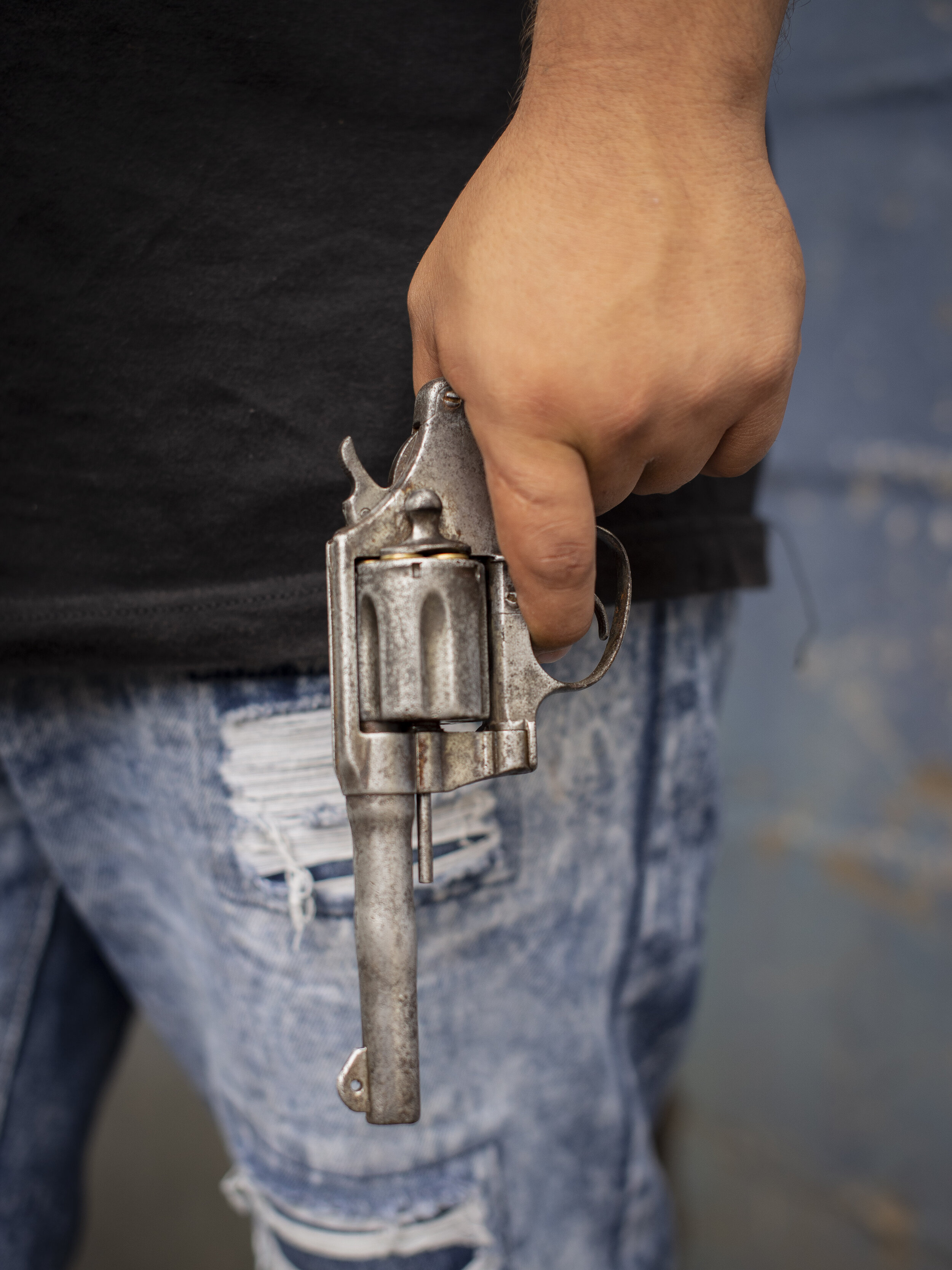   A Barrio 18 gang member holding a pistol in San Salvador. 